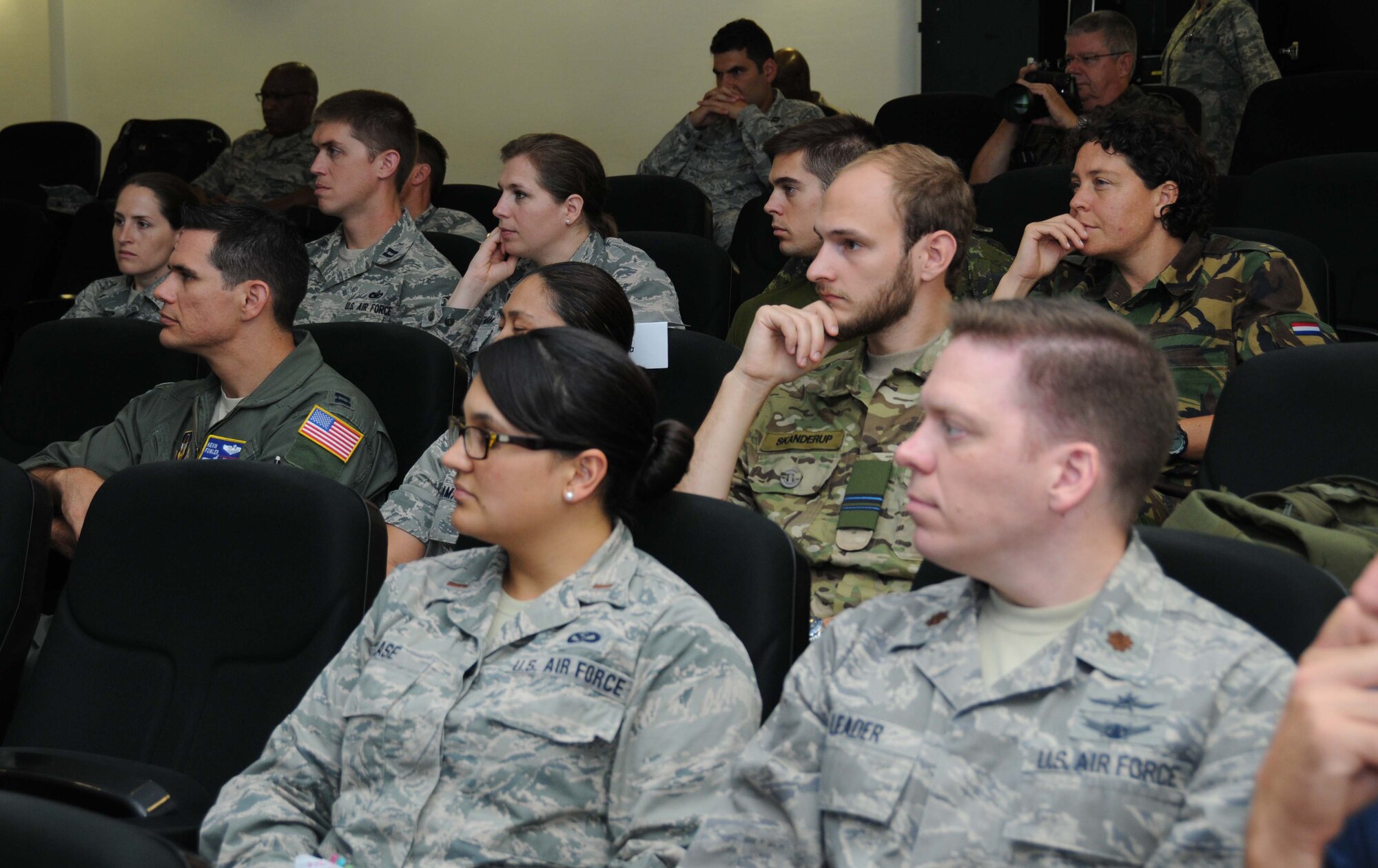 Second Lt. Ashley Klase, Ohio Air National Guard, and Maj. Jeremy Leader, an Air Force reservist assigned to Joint Base Langley-Eustis, Virginia, listen to Maj. Gen. Mark Loeben's presentation about U.S. European Command July 21.  They participated in the International Junior Officer Development Seminar, hosted by Air Force Reserve Command at Ramstein Air Base, Germany, from July 18-25, 2015. Forty-six officers from seven nations participated in this year's IJOLDS. (U.S. Air Force photo/Col. Rob Palmer)

