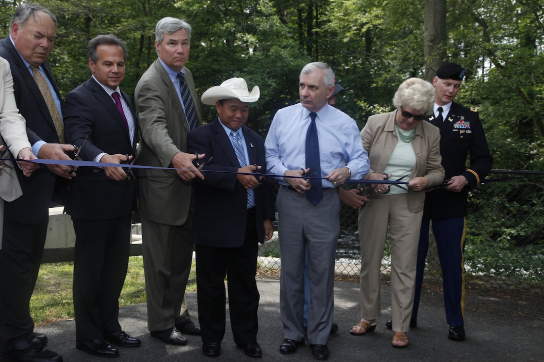 Col. Christopher Barron, District Commander, joins partners in cutting the ribbon on the successful Ten Mile River Restoration Project on June 19, 2015.