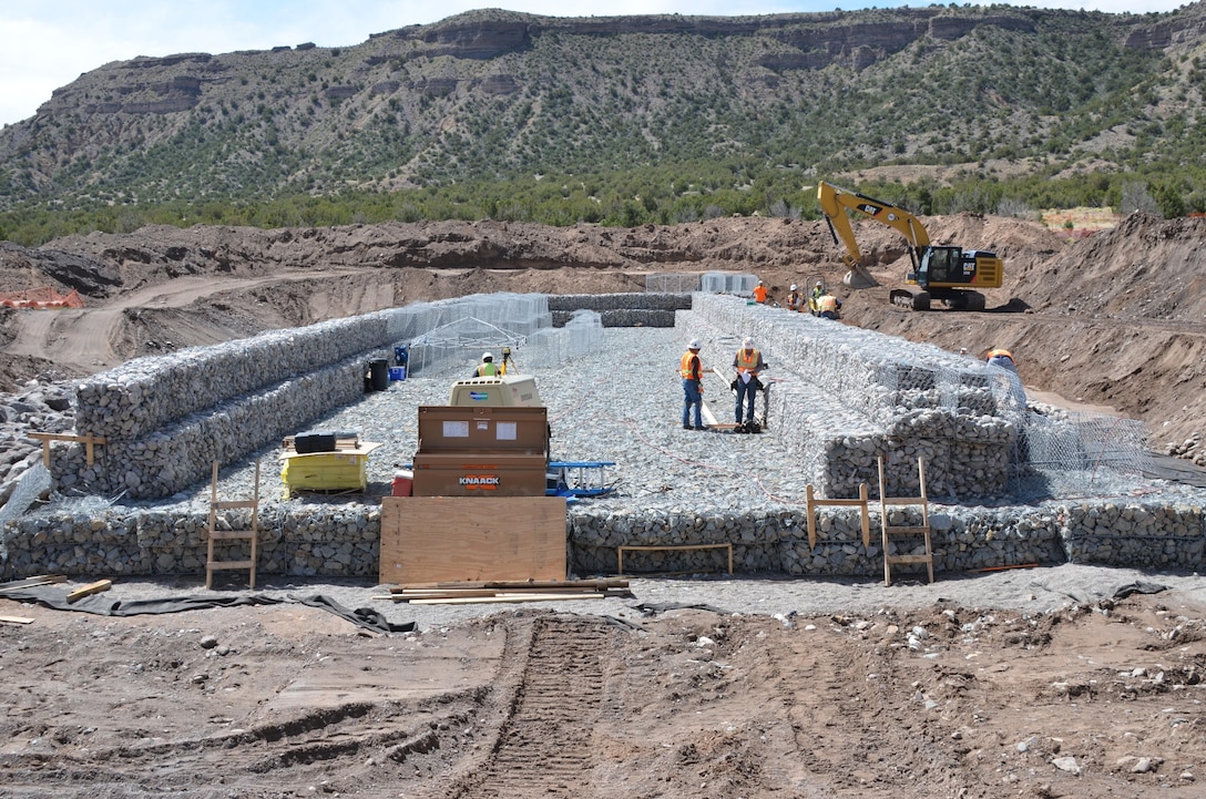 As Climate Changes, Santa Clara Strives To Become Resilient To Worsening Fires, Floods: Two gabion check structures are being built upstream of the village of Santa Clara Pueblo in the lower Santa Clara Canyon. The rock-filled basket structures, designed to slow flood flows and catch debris and sediment, range between 350 feet and 450 feet in length and are less than 25 feet above grade. Courtesy Elizabeth Lockyear/U.S. Army Corps of Engineers, Albuquerque District