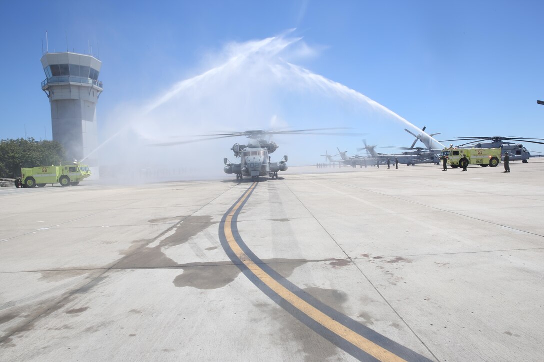 Marines with Aircraft Rescue and Firefighting spray water on a CH-53E Super Stallion piloted by Col. Anthony Bianca, commanding officer of Marine Aircraft Group (MAG) 16, after his final flight as MAG-16 commanding officer aboard Marine Corps Air Station Miramar, California, July 24. Bianca took command of MAG-16 in August 2013 and is slated to relinquish command later this month. (U.S. Marine Corps photo By Lance Cpl. Kimberlyn Adams/Released)