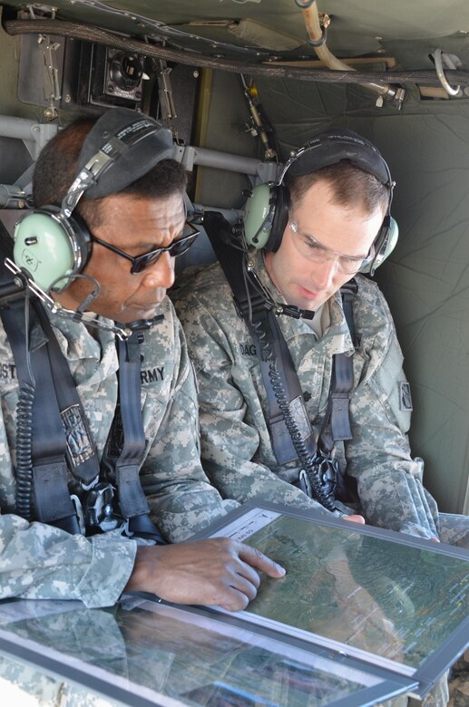 As Climate Changes, Santa Clara Strives To Become Resilient To Worsening Fires, Floods: Lt. Gen. Thomas Bostick, left, and Albuquerque District Commander Lt. Col. Patrick Dagon of the U.S. Army Corps of Engineers examine a map detailing the route of a helicopter tour June 4, to view work being done to protect Santa Clara Pueblo from increased flood risks caused by the 2011 Las Conchas Fire. Courtesy Elizabeth Lockyear/U.S. Army Corps of Engineers, Albuquerque District