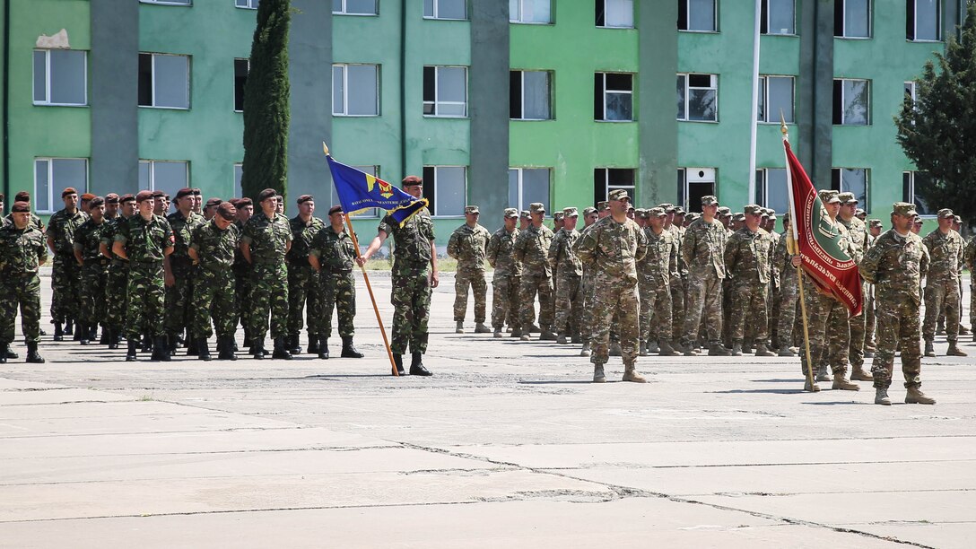 Romanian and Georgian soldiers stand alongside Latvian, Lithuanian and Bulgarian soldiers and U.S. Marines during the Exercise Agile Spirit closing ceremony July 22, 2015, at Vaziani Training Area, Georgia.  Exercise Agile Spirit 15 involved a NATO Response Force level combined operation that incorporated a wide range of planning and execution challenges during a command post exercise and a field training exercise. The U.S. Marines with Black Sea Rotational Force and 10th Marine Regiment supported the exercise.
