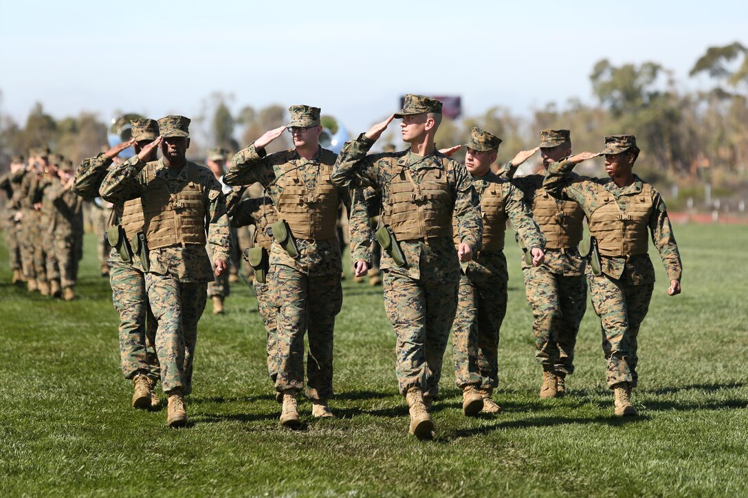 U.S. Marines with Headquarters and Headquarters Squadron (H&HS) conduct a pass in review during the H&HS Relief and Appointment Ceremony aboard Marine Corps Air Station Miramar San Diego, Calif., on March 5, 2014. The Relief and Appointment signifies the "passing of responsibility" from one senior enlisted advisor to another.(U.S. Marine Corps photo by Cpl. Daniel V. Gonzales/RELEASED)