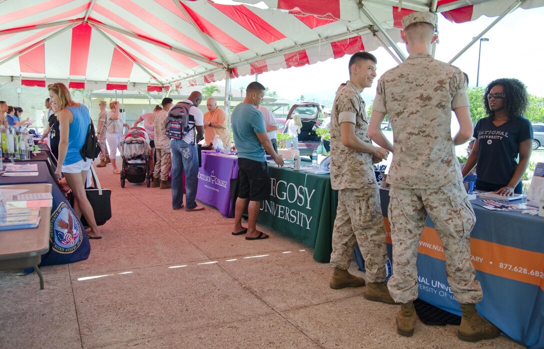 Attendees browse resource tables during the Education Expo at Mokapu Mall, July 23, 2015. More than 180 attendees visited more than 20 resource tables, many featuring colleges and universities, at Mokapu Mall to share information with the Marines and Sailors of MCB Hawaii about Marine Corps Community Services, education opportunities and more. In addition, Marines were given the opportunity to receive credit for the College 101 Education Brief by attending the expo, provided they met certain requirements, such as correctly completing a series of written questions at the Education Center tent and visiting at least five schools during the expo. The questions included information about tuition assistance policy and procedure. The College 101 Education Brief is held Wednesdays from 11:30 a.m. to 12:30 p.m. at the Education Center. Per Marine Corps Order 1560.25, Marines must attend the brief to be eligible for TA. The mission of Marine Corps Base Hawaii provides facilities, programs and services in direct support of units, individuals and families in order to enhance and sustain combat readiness for all operating forces and tenant organizations aboard the installation. (U.S. Marine Corps photo by Kristen Wong/Released)