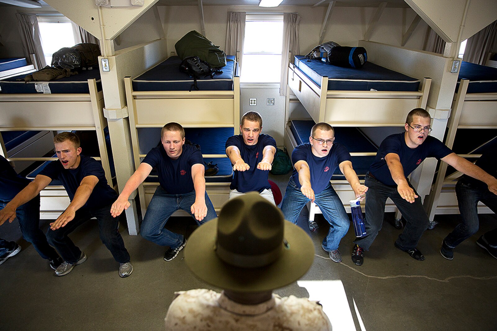 Sgt. Donald Jackson (center), a drill instructor from Marine Corps Recruit Depot San Diego, teaches Marine enlistees discipline during a Recruiting Station Seattle pool function at the Yakima Training Center in Yakima, Wash., July 17, 2015. During the event, recruiters teamed with drill instructors to physically and mentally prepare enlistees from Washington and Idaho for boot camp. The enlistees, part of the Marine Corps delayed entry program, are awaiting their ship dates. Jackson, 28, is from Suffolk, Va. (U.S Marine Corps photo by Sgt. Reece Lodder)