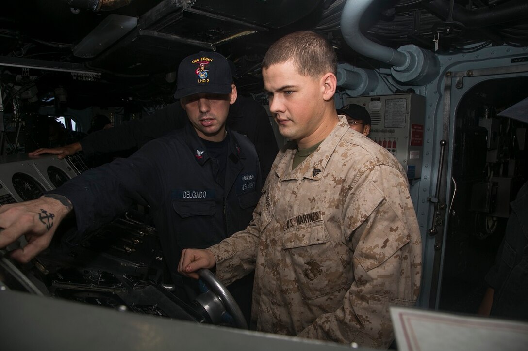 INDIAN OCEAN (July 24, 2015) U.S. Marine Cpl. Houston Davis gets behind the wheel of the amphibious assault ship USS Essex (LHD 2) after being awarded the 15th Marine Expeditionary Unit’s “Marine of the Week.” Davis is a member of India Company, Battalion Landing Team 3rd Battalion, 1st Marine Regiment, 15th MEU and is part of the 15th MEU Maritime Raid Force’s security element. While serving as a team leader with the security element, Davis ensured the preparation of two of his Marines to take part in the Lima Company Machine Gun Leaders Course and five Marines to take part in the BLT Marine Corps Martial Arts Program course. His dedication and knowledge has been vital in ensuring the preparedness and continued development of the security element’s capabilities. (U.S. Marine Corps photo by Cpl. Anna Albrecht/Released)