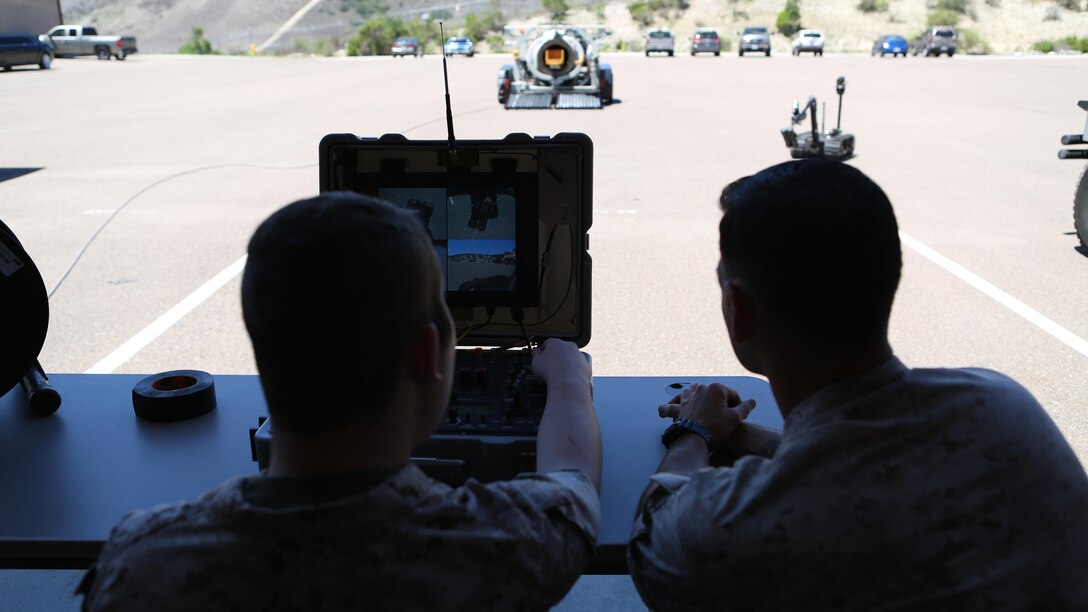 James Gallant, a young man diagnosed with brain cancer, operates the TALON Explosive Ordnance Disposal robot with Marines of 1st EOD Company, 1st Marine Logistics Group, aboard Camp Pendleton, Calif., July 25, 2015. Collaborating with the Make-A-Wish Foundation, 1st EOD helped James experience what being an EOD technician is like by giving him a tour through their library of ordnance and EOD tools, teaching him to operate the TALON bomb disposing robot and presenting him with his own desert utilities and EOD badge.