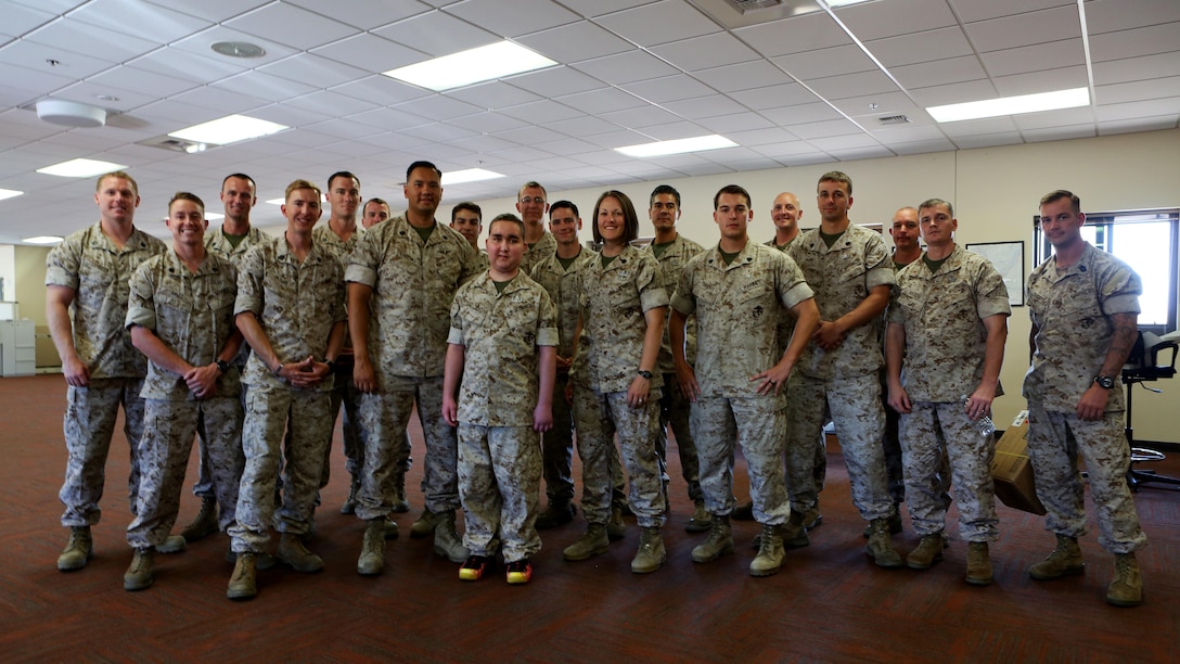 James Gallant, a young man diagnosed with brain cancer, poses for a photo with Marines of 1st Explosive Ordnance Disposal Company, 1st Marine Logistics Group, aboard Camp Pendleton, Calif., July 25, 2015. Collaborating with the Make-A-Wish Foundation, 1st EOD helped James experience what being an EOD technician is like by giving him a tour through their library of ordnance and EOD tools, teaching him to operate the TALON bomb disposing robot and presenting him with his own desert utilities and EOD badge.