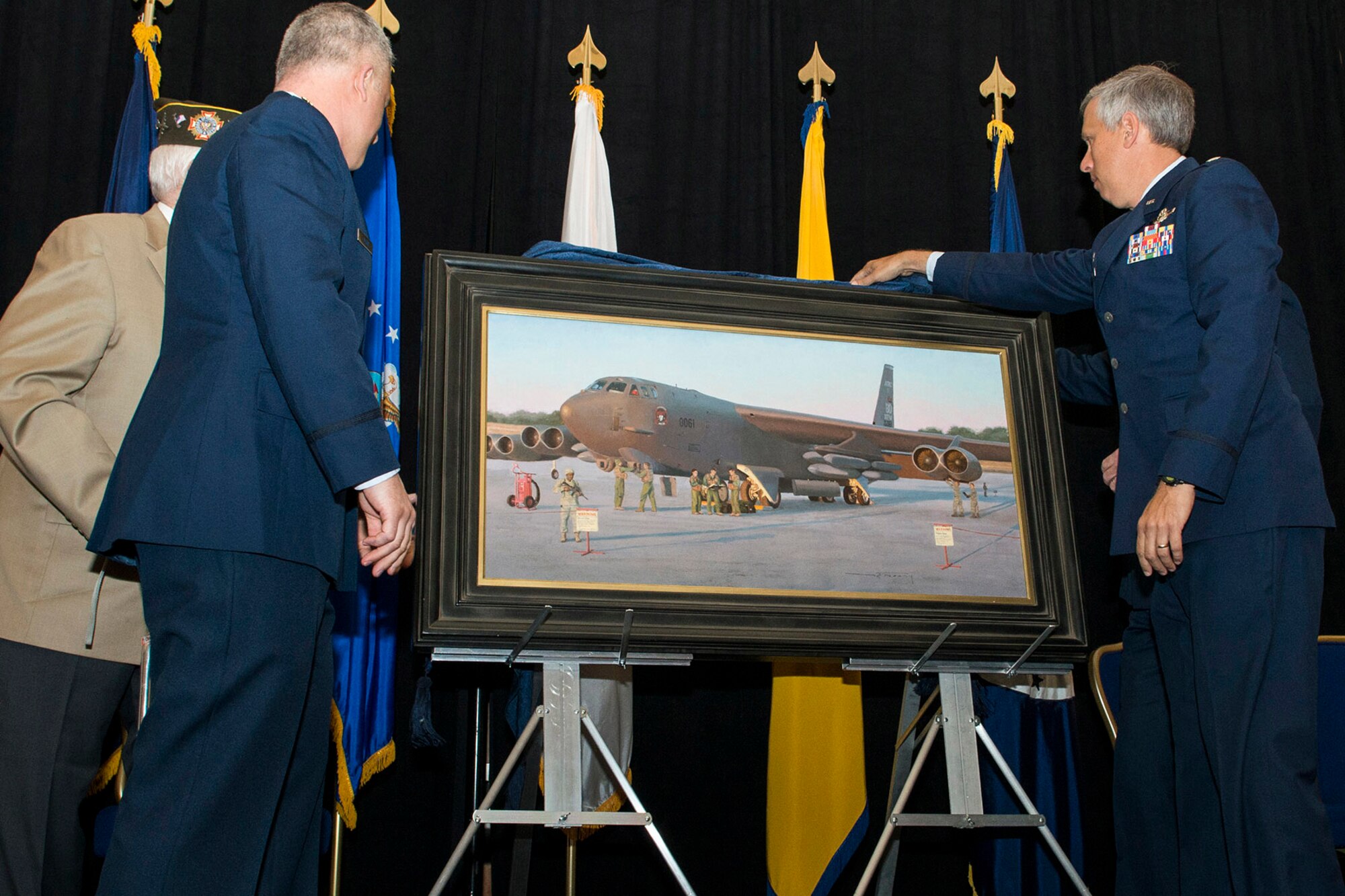 The Chief of the Air Force Reserve Lt. Gen. James Jackson presented the painting "Deterrence on Demand" to Brig. Gen. Thomas Clark, the Mobilization Assistant to the Assistant Chief of Staff for Strategic Deterrence and Nuclear Integration, Headquarters U.S. Air Force during the Reserve Officers Association National Convention in Washington D.C. Jul. 27, 2015. Clark accepted the painting on behalf of the Air Force Art Program.  Jackson was joined by Col. Bruce Cox, the commander of the 307th Bomb Wing and Lt. Col. Rob Burgess, 343rd Bomb Squadron, Barksdale Air Force Base, La., Maj. Warren Neary, Air Force Reserve Historian and artist and Technical Sgt. John Wright, a radar operator in the 307th Bombardment Group Heavy, a unit activated for World War II. (U.S. Air Force photo by Master Sgt. Gregory Steele)  