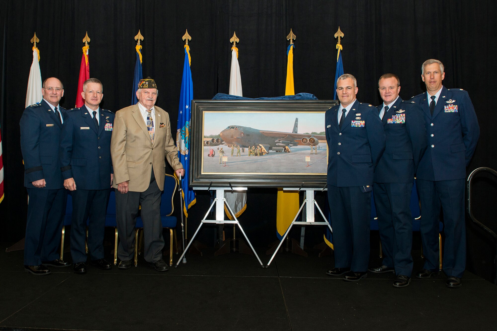 The Chief of the Air Force Reserve Lt. Gen. James Jackson poses for a picture with Brig. Gen. Thomas Clark, the Mobilization Assistant to the Assistant Chief of Staff for Strategic Deterrence and Nuclear Integration, Headquarters U. S. Air Force, Col. Bruce Cox, the commander of the 307th Bomb Wing, Lt. Col. Rob Burgess, commander of the 343rd Bomb Squadron, Barksdale Air Force Base, La., Maj. Warren Neary, Air Force Reserve Historian and artist and Technical Sgt. John Wright, a radar operator in the 307th Bombardment Group Heavy during the Reserve Officers Association National Convention in Washington D.C. Jul. 27, 2015. Jackson presented the painting "Deterrence on Demand" to Clark who accepted it on 
behalf of the Air Force Art Program. "Deterrence on Demand" depicts Airmen of the 307th Bomb Wing generating their aircraft for a nuclear exercise with aircrew, maintainers and security forces members. The 307th Bomb Wing reached a significant milestone when it became the first Air Force Reserve unit in Air Force history to be nuclear certified, after it excelled during its initial nuclear surety inspection. (U.S. Air Force photo by Master Sgt. Gregory Steele)  

