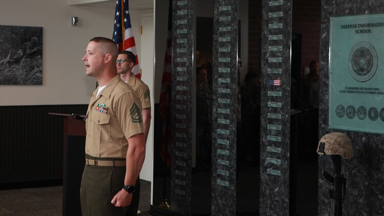 Gunnery Sgt. Chance Haworth, the Marine Detachment senior enlisted advisor at the Defense Information School at Fort George G. Meade, Md, gives final roll call July 27, 2015. Corporal Sara Medina and Lance Cpl. Jacob Hug had their names mounted to the Hall of Heroes display at DINFOS honoring their service after losing their lives in a helicopter crash during relief efforts in Nepal.