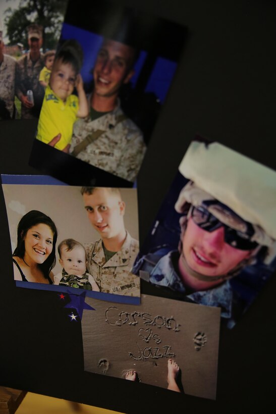 Photographs of Sgt. Carson Holmquist with his wife Jasmine and son Wyatt, decorate a memorial at his funeral July 25, 2015 in Grantsburg, Wis. Holmquist, a motor transport maintenance chief with Battery M, 3rd Battalion, 14th Marine Regiment, 4th Marine Division, Marine Forces Reserve, was killed in an attack at the Naval Operation Support Center and Marine Corps Reserve Center in Chattanooga, Tenn. on July 16, 2015. Marines, family, friends and the community of Grantsburg gathered to honor the memory and sacrifice of Holmquist and his fallen brothers-in-arms. 