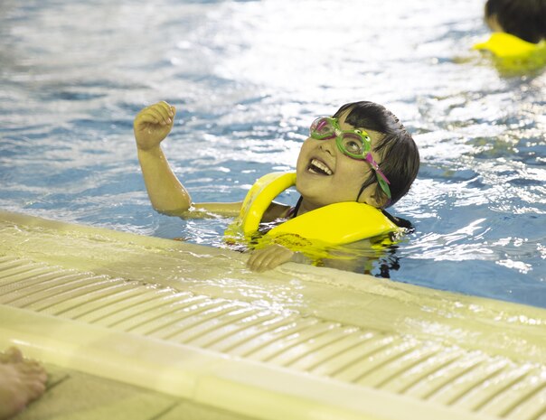 Students from Kawashimo Yochien in Iwakuni City, celebrate their last day at the IronWorks pool aboard Marine Corps Air Station Iwakuni, Japan, July 21, 2015. The Japanese senior kindergarten class visited the pool six times this July as part of an annual tradition. When weather permits, the children and teachers use the station outdoor pool, but due to inclement weather on teh last pool day, guests moved to the indoor pool.