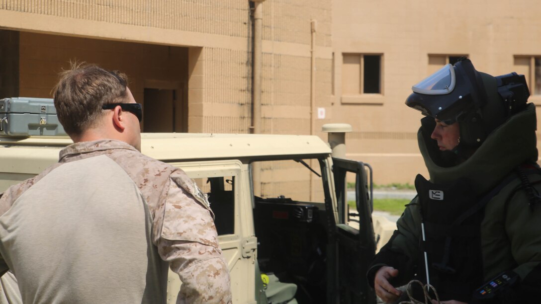 Marines with Explosive Ordnance Disposal Company, 8th Engineer Support Battalion, discuss the findings of an area search during a field exercise aboard Camp Lejeune, North Carolina, July 22, 2015. The Marines faced various scenarios during the exercise, which included IEDs located in buildings, sports stadiums, and explosives used in hostage situations, each of which prepared the EOD technicians to face threats found on deployments and at home.