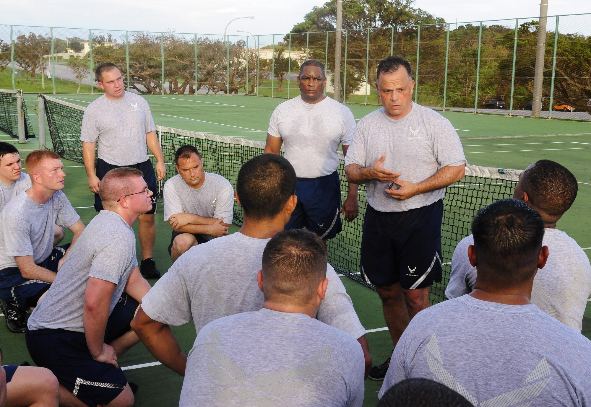 U.S. Air Force Chief Master Sgt. Matthew Caruso, U.S. Air Force Special Operations Command command chief, speaks to Airmen from the 353rd Special Operations Maintenance Squadron following a physical training session with the squadron on Kadena Air Base, Japan, July 21, 2015. Caruso joined the squadron for a physical training session and ended the gathering with words about professionalism, resilience and pride. He also presented challenge coins to highlight the efforts of outstanding performers within the unit. (U.S. Air Force photo by Airman 1st Class John Linzmeier)