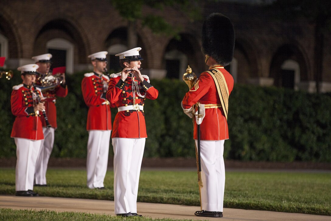 The Marine Corps Band preforms during an evening parade at Marine Barracks Washington, D.C., July 24, 2015. Gen. Joseph F. Dunford Jr., 36th commandant of the Marine Corps, was the official host and Adm. Jonathan W. Greenert, chief of Naval Operations, was the guest of honor. The Evening Parade summer tradition began in 1934, and features the Silent Drill Platoon, the U.S. Marine Band, the U.S. Marine Drumand Bugle Corps alongside two marching companies. More than 3,500 guests attend the parade every week. (U.S. Marine Corps photo by Lance Cpl. Alex A. Quiles/ Released)  
