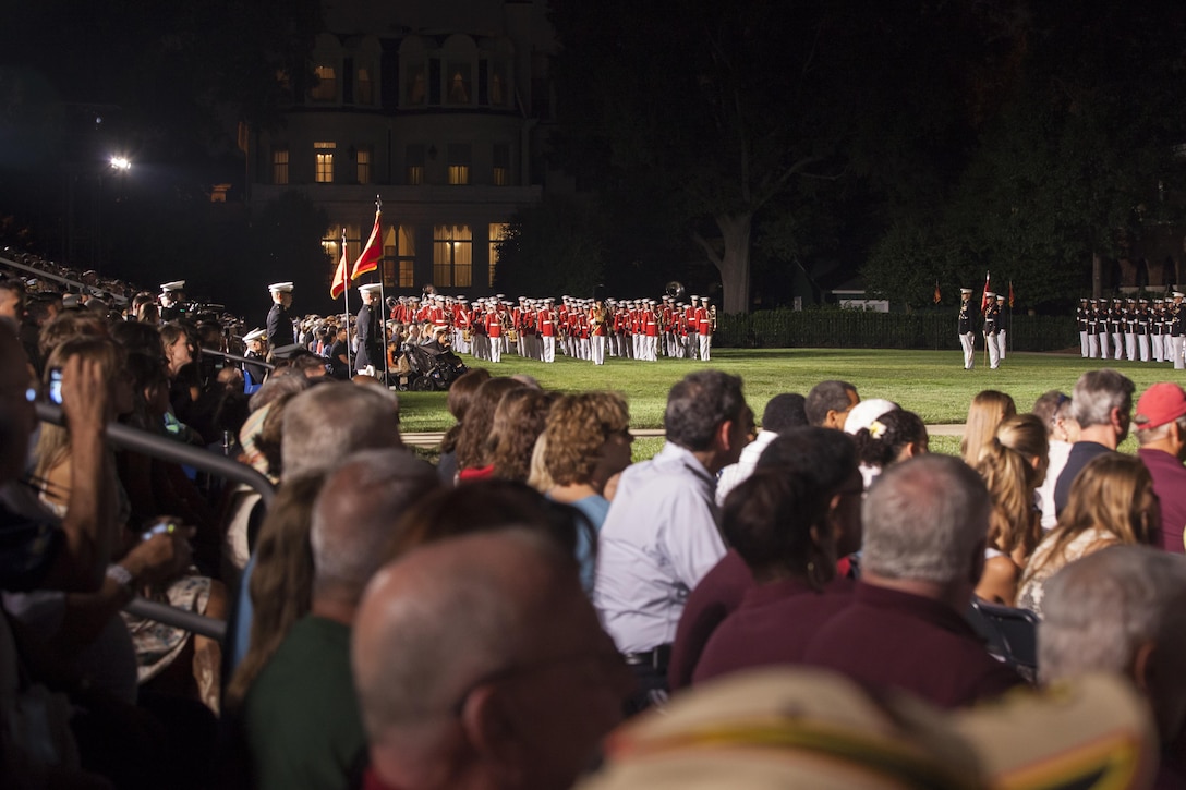 U.S Marines with Marines Barracks Washington (MBW), perform during the evening parade at MBW, D.C., July 24, 2015. Gen. Joseph F. Dunford, Jr., Commandant of the Marine Corps, was the official host and Adm. Jonathan W. Greenert, Chief of Naval Operations, was the guest of honor. The Evening Parade summer tradition began in 1934, and features the Silent Drill Platoon, the U.S. Marine Band, the U.S. Marine Drum and Bugle Corps alongside two marching companies. More than 3,500 guests attend the parade every week. (U.S. Marine Corps photo by Lance Cpl. Kayla V. McTaw/Released)
