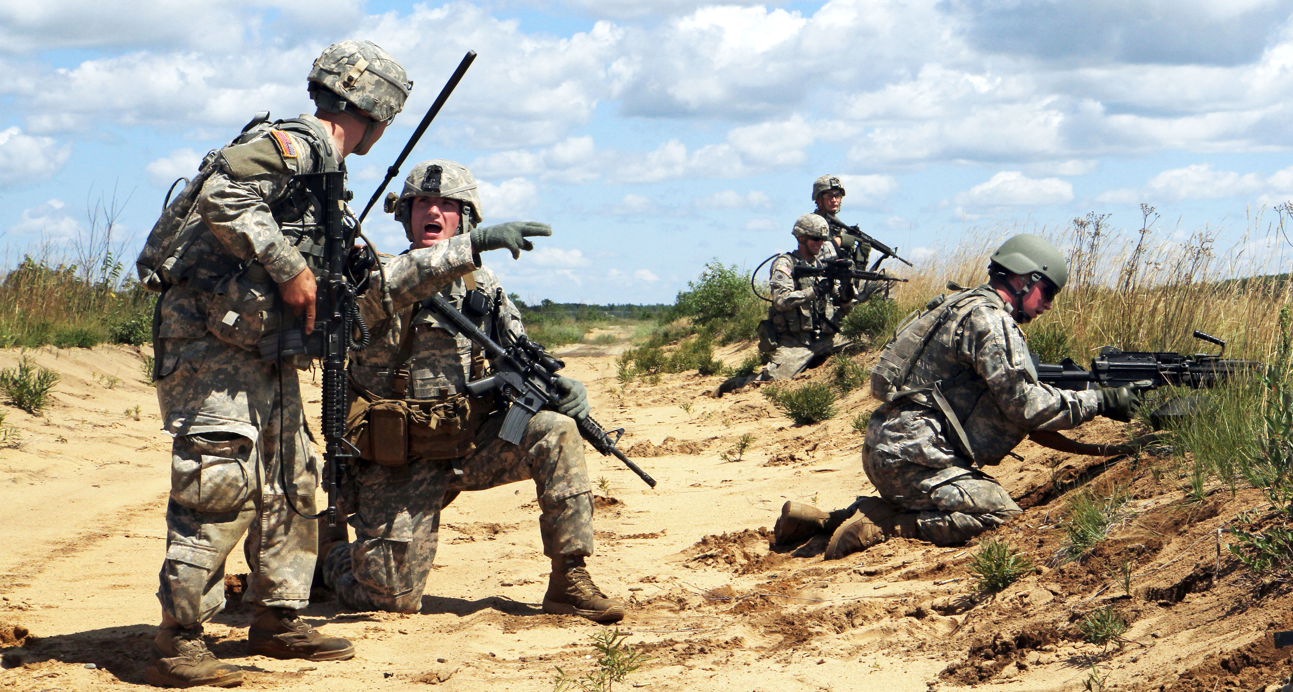 U s army sgt gregory padilla second from left gives a status report