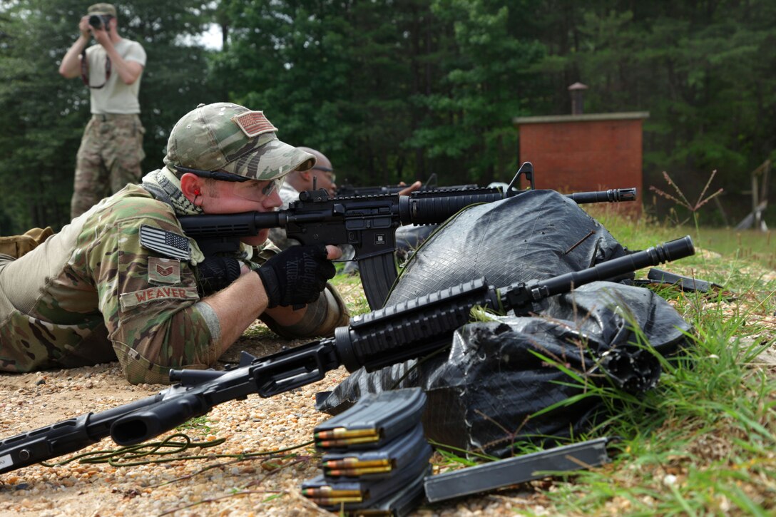 Air Force Staff Sgt. Sam Weaver participates in the weapons qualification range with the M4 carbine rifle during the 3rd annual U.S. Army Spc. Hilda I. Clayton Best Combat Camera 2015 on Fort Meade, Md., July 14, 2015. Weaver is  a combat camera airman assigned to the 1st Combat Camera Squadron. The competition honors the fallen combat cameraman, Army Spc. Hilda I. Clayton, who gave her life July 2, 2013, in Afghanistan as a part of Operation Enduring Freedom. 