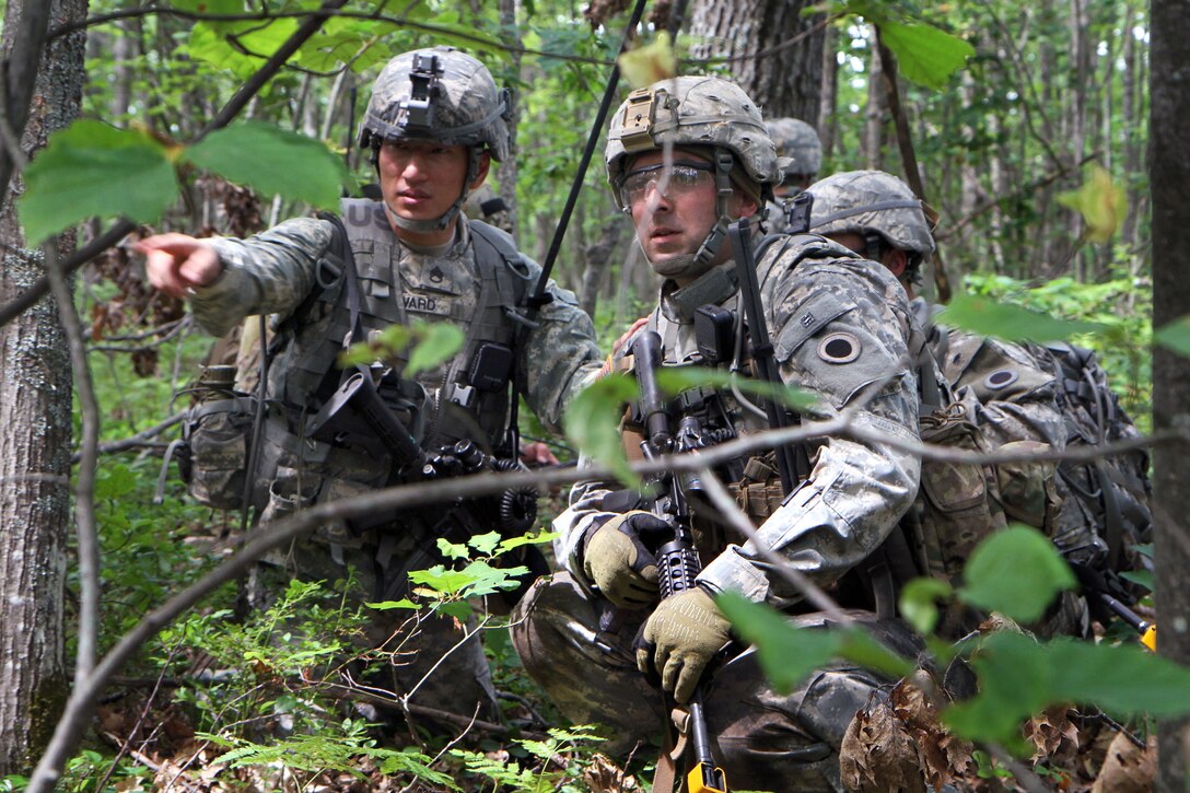 U.S. Army Staff Sgt. Matthew Rivard, left, directs fellow team leader, U.S. Army Sgt. Jacob Schrot, while on patrol during Northern Strike 15 on Camp Grayling Joint Maneuver Training Center, Mich., July 20, 2015. Rivard is a team leader and Schrot are assigned to the 1st Battalion, 126th Cavalry Regiment.