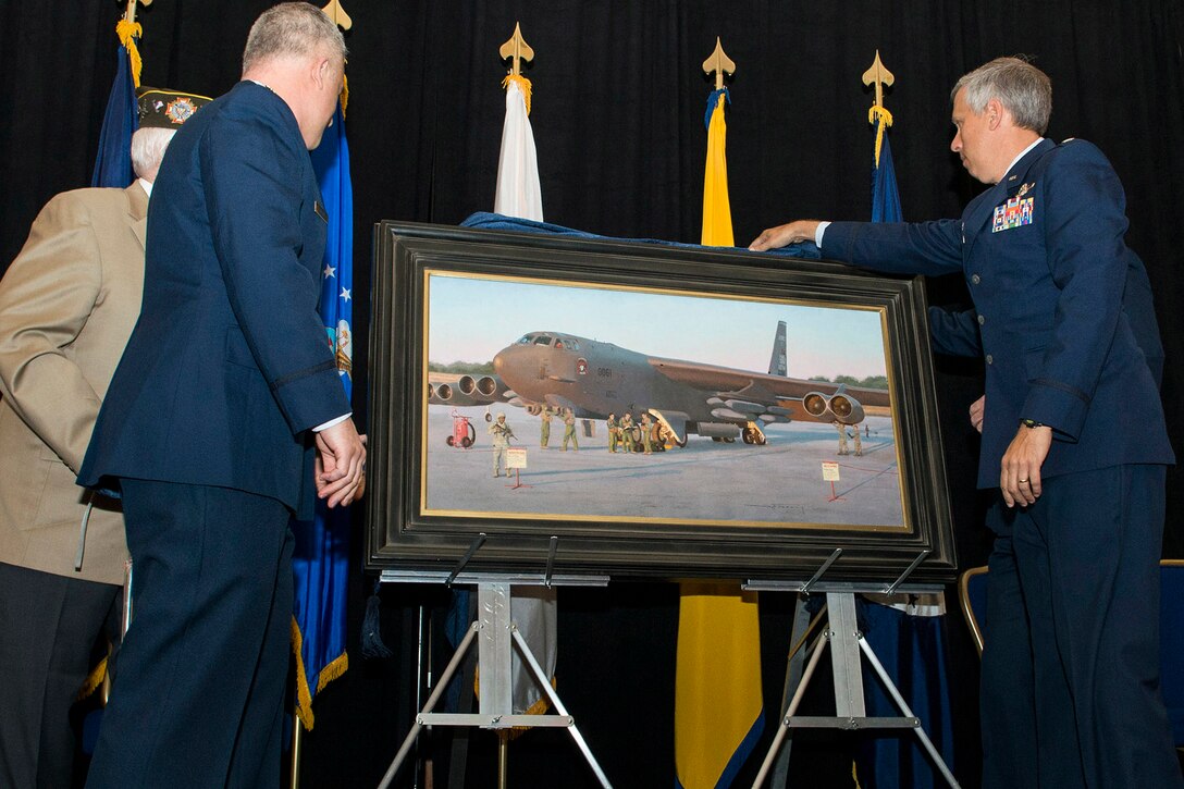 U.S. Air Force Lt. Col. Robert Burgess (right), 343rd Bomb Squadron commander, helps unveil a painting titled “Deterrence on Demand” during the Reserve Officers Association National Convention, Washington D.C., July 27, 2015. The painting depicts Airmen of the 307th Bomb Wing and 343rd Bomb Squadron generating a B-52H Stratofortress during a nuclear exercise, marking a milestone for the wing when it became the first unit in the Air Force Reserve to gain nuclear certification. (U.S. Air Force photo by Master Sgt. Greg Steele/Released)