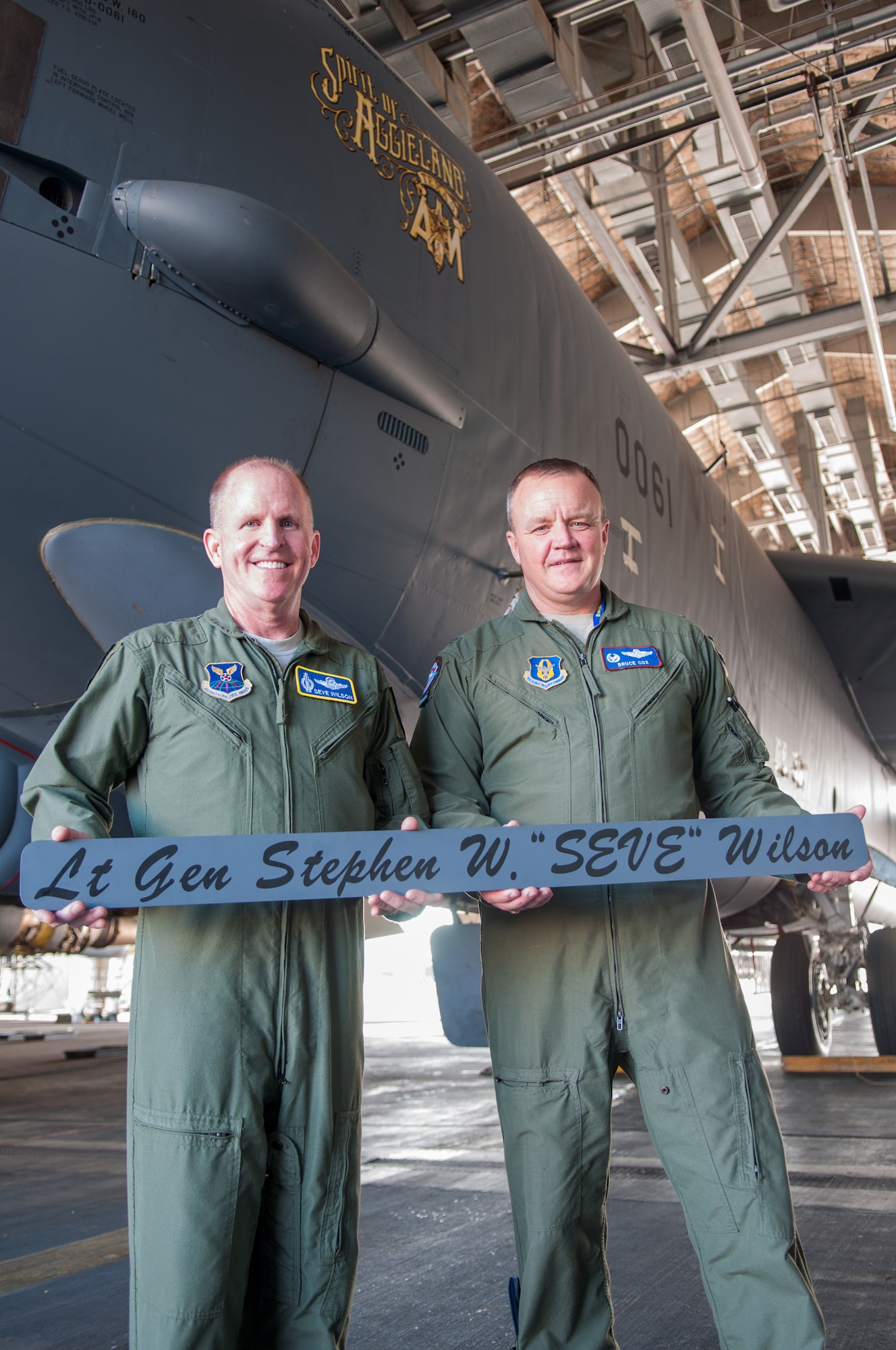 U.S. Air Force Lt. Gen. Stephen Wilson, commander of Air Force Global Strike Command accepts a name plaque from Col. Bruce Cox, 307th Bomb Wing commander, at Barksdale Air Force Base, La. on July 23. Cox unveiled the new nose art on the flagship B-52 H Stratofortress of the 307th Bomb Wing, “The Spirit of Aggieland,” on the day that Wilson took his final flight as the commander of the AFGSC. Both Wilson and Cox are alumni of Texas A&M University. (U.S. Air Force photo by Master Sgt. Dachelle Melville/Released)