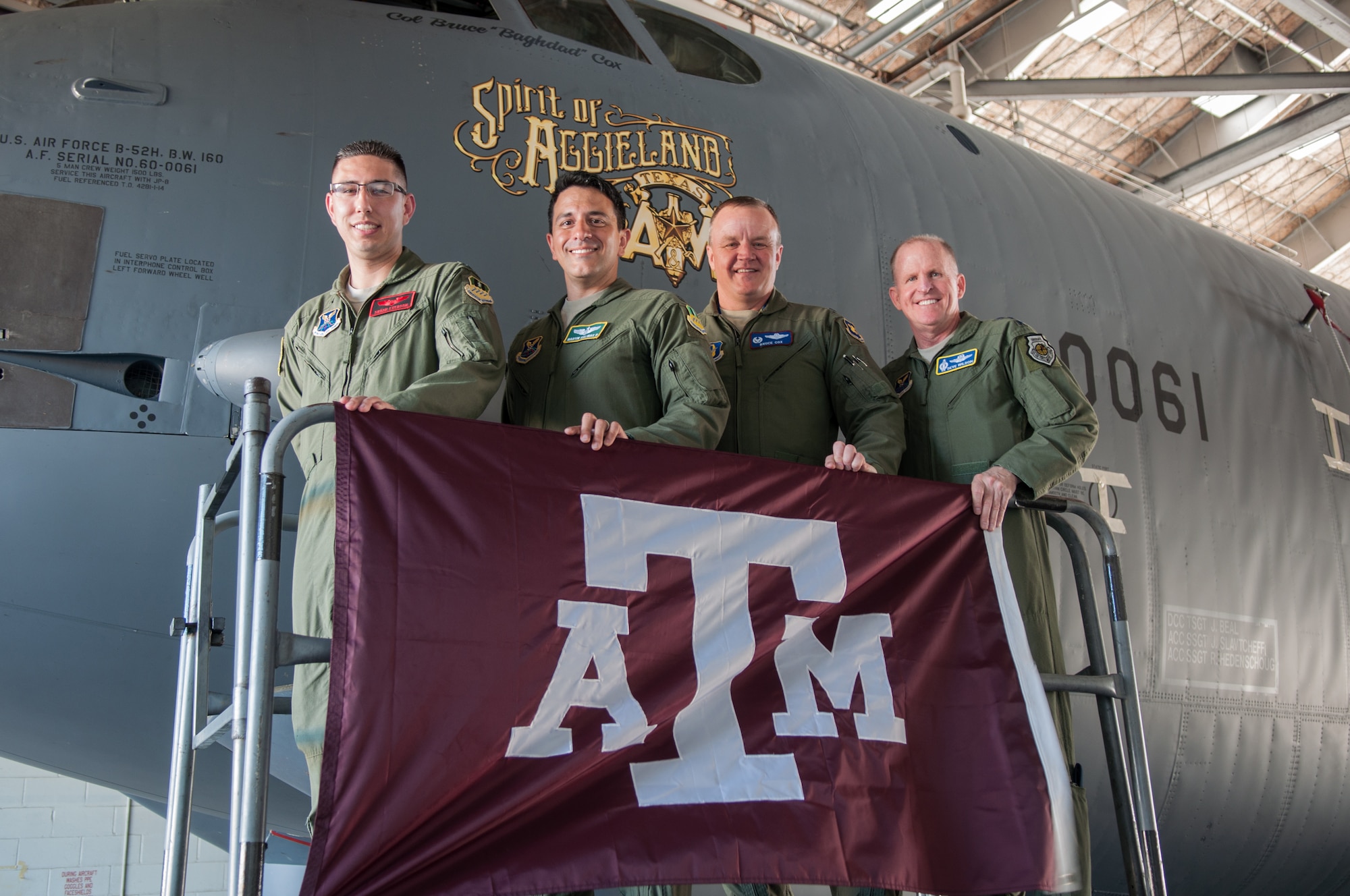 Alumni from Texas A&M University that are now members of the U. S. Air Force gather to see the new nose art on the flagship of the 307th Bomb Wing “The Spirit of Aggieland” on Barksdale Air Force Base, La. on July 23, 2015. Alumni include (from left to right) Capt. Christian Everson, an Electronic Warfare Officer assigned to the 96th Bomb Squadron, Lt. Col. Martin Salinas, Inspector General for the 2nd Bomb Wing, Col. Bruce Cox, Commander of the 307th Bomb Wing, and Lt. Gen. Stephen Wilson, Commander of Air Force Global Strike Command. Cox chose to unveil the nose art on the day that Wilson took his final flight as the commander of the AFGSC. “The Spirit of Aggieland,” is dedicated to former and future cadets that graduated from Texas A&M University's Corps of Cadets Program. (U.S. Air Force photo by Master Sgt. Dachelle Melville/Released)