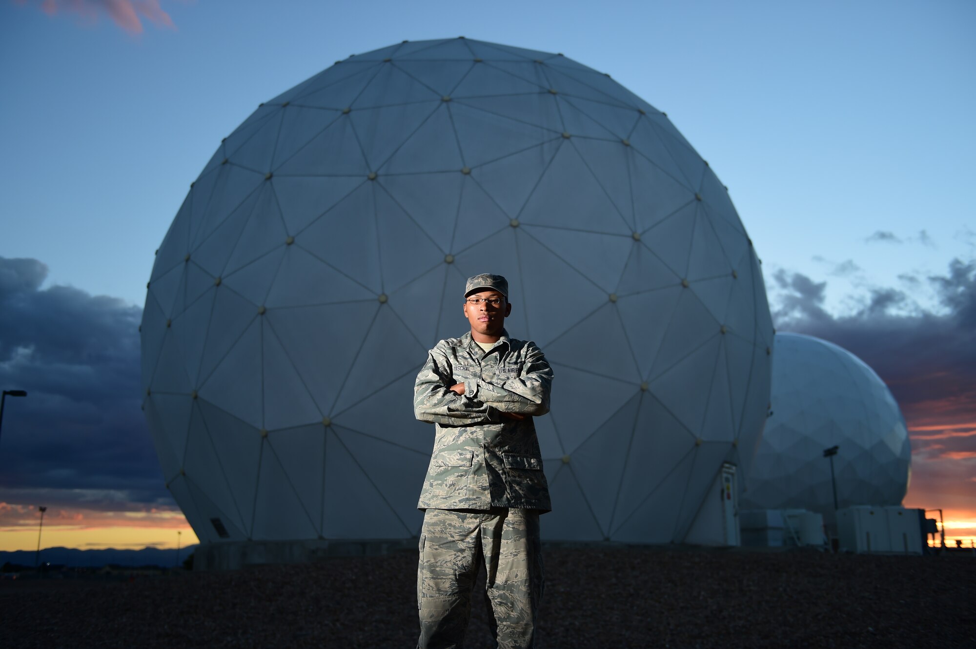 Senior Airman Justin D. Paschal, 2nd Space Warning Squadron data systems operator, stands in front of a radome that helps him communicate with spacecraft July 22, 2015, at Buckley Air Force Base, Colo. Paschal works to analyze data collected from a spacecraft and reports what is collected. (U.S. Air Force photo by Airman 1st Class Luke W. Nowakowski/Released)