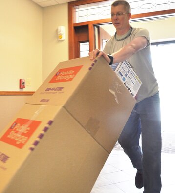 Chaplain (Capt.) Paul Mount, 931st Air Refueling Group chaplain, moves boxes at the entrance of the newly renovated base chapel at McConnell Air Force Base, Kan., July 27, 2015. With $2.1 million in renovations recently completed, services in the Base Chapel will resume during the August Unit Training Assembly.  (U.S. Air Force photo by Tech. Sgt. Abigail Klein)
