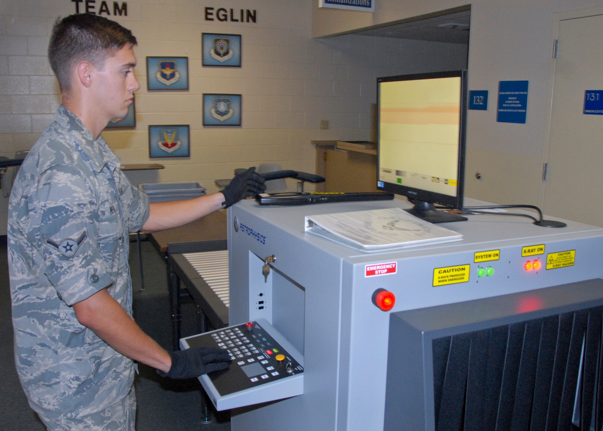 Airman Cory Meade, an Eglin passenger terminal member, screens luggage before it’s placed on a military flight.  The terminal follows all guidelines set forth by the Transportation Security Administration.  (U.S. Air Force photo/Kevin Gaddie)