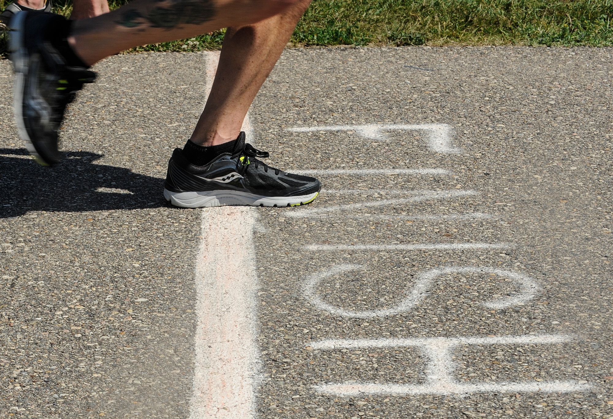 Chief Master Sgt. Geoff Weimer, 5th Bomb Wing command chief, crosses the finish line on mile 51 of a 52 mile run at Minot Air Force Base, N.D., July 24, 2015. Weimer completed the run to support the Air Force Enlisted Village and Chief Master Sergeant Scholarship Fund. (U.S. Air Force photo/Senior Airman Stephanie Morris)