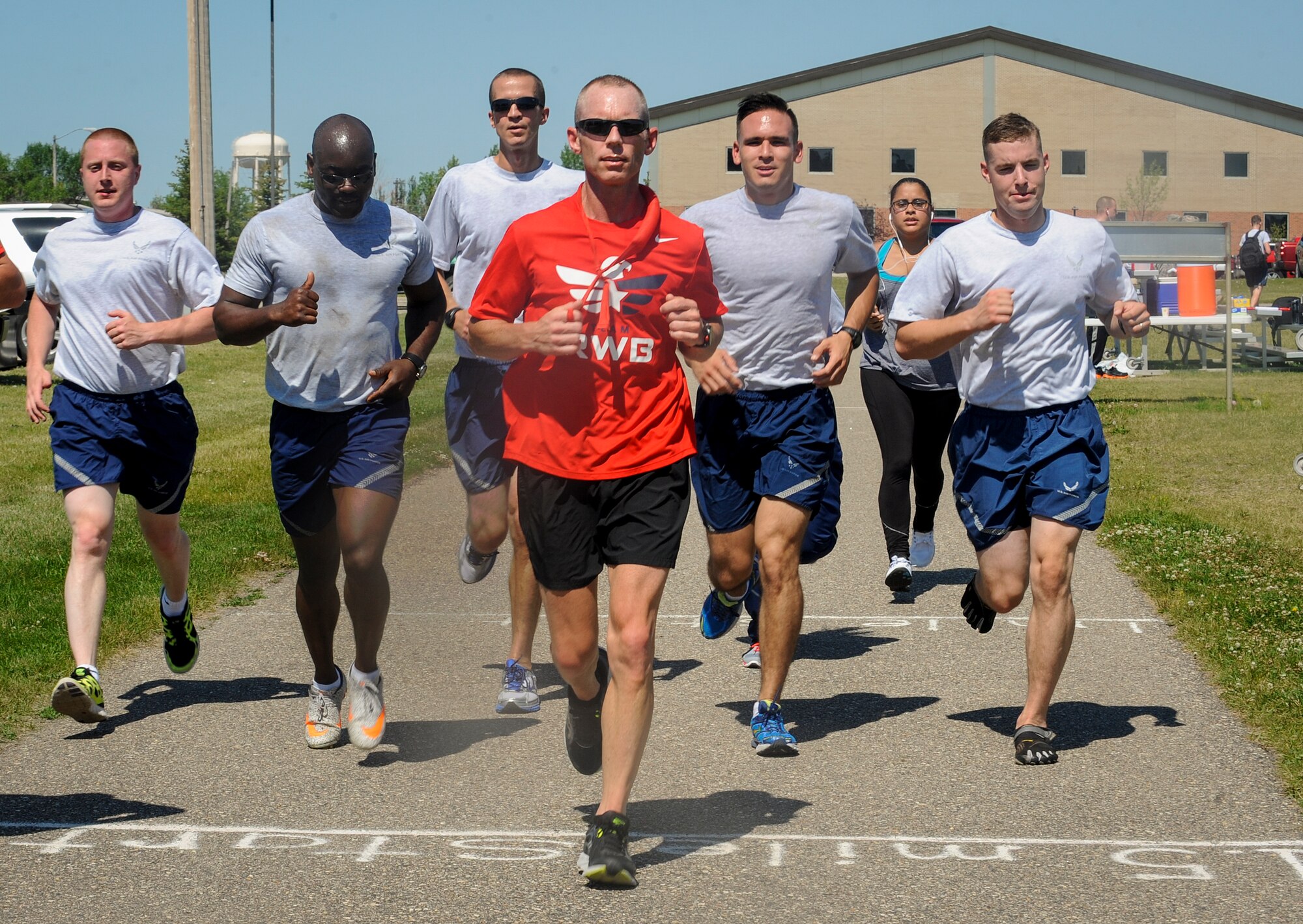 Chief Master Sgt. Geoff Weimer, 5th Bomb Wing command chief, leads a group of Airmen on the 50th mile of a 52 mile run at Minot Air Force Base, N.D., July 24, 2015. To prepare for the event, Weimer made distance adjustments to his regular running routine and factored in fatigue and physical stress. (U.S. Air Force photo/Senior Airman Stephanie Morris)
