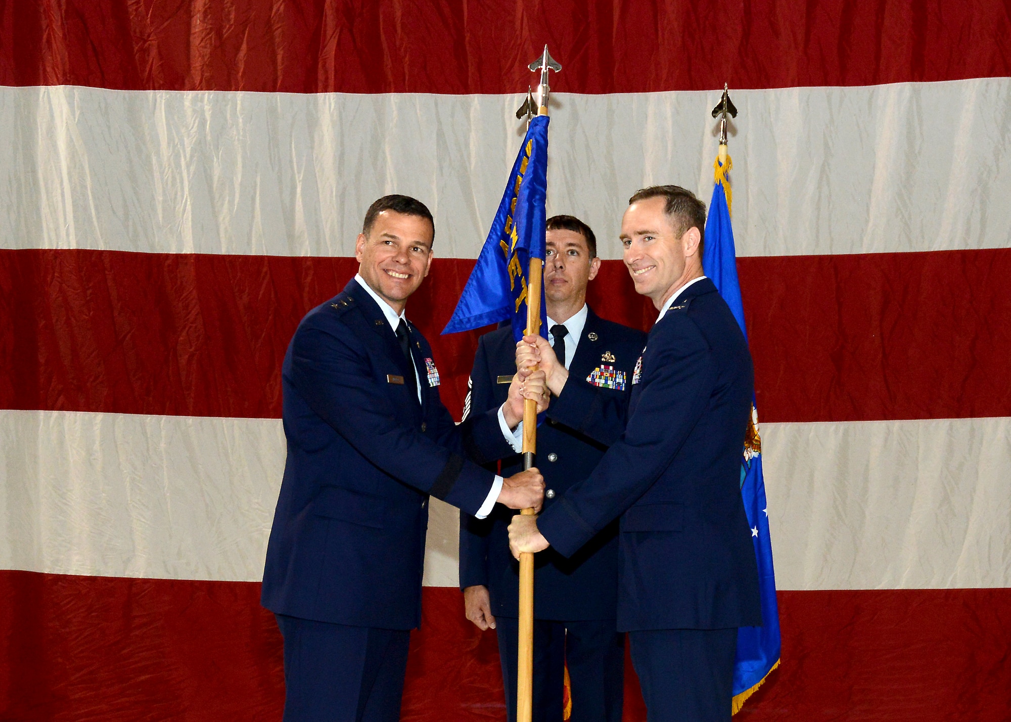 Maj. Gen. Matthew H. Molloy (left), Air Force Operational Test and Evaluation Center commander, poses for a photo with new AFOTEC Detachment 1 commander, Col. Steven M. Ross, after Ross accepted the unit flag for his new assignment during a change of command ceremony July 24. AFOTEC Det. 1 plans, conducts and reports on realistic, objective, and impartial operational test and evaluation of the Air Force's fifth-generation F-35 fighter jet. (U.S. Air Force photo by Patric Lovato)  