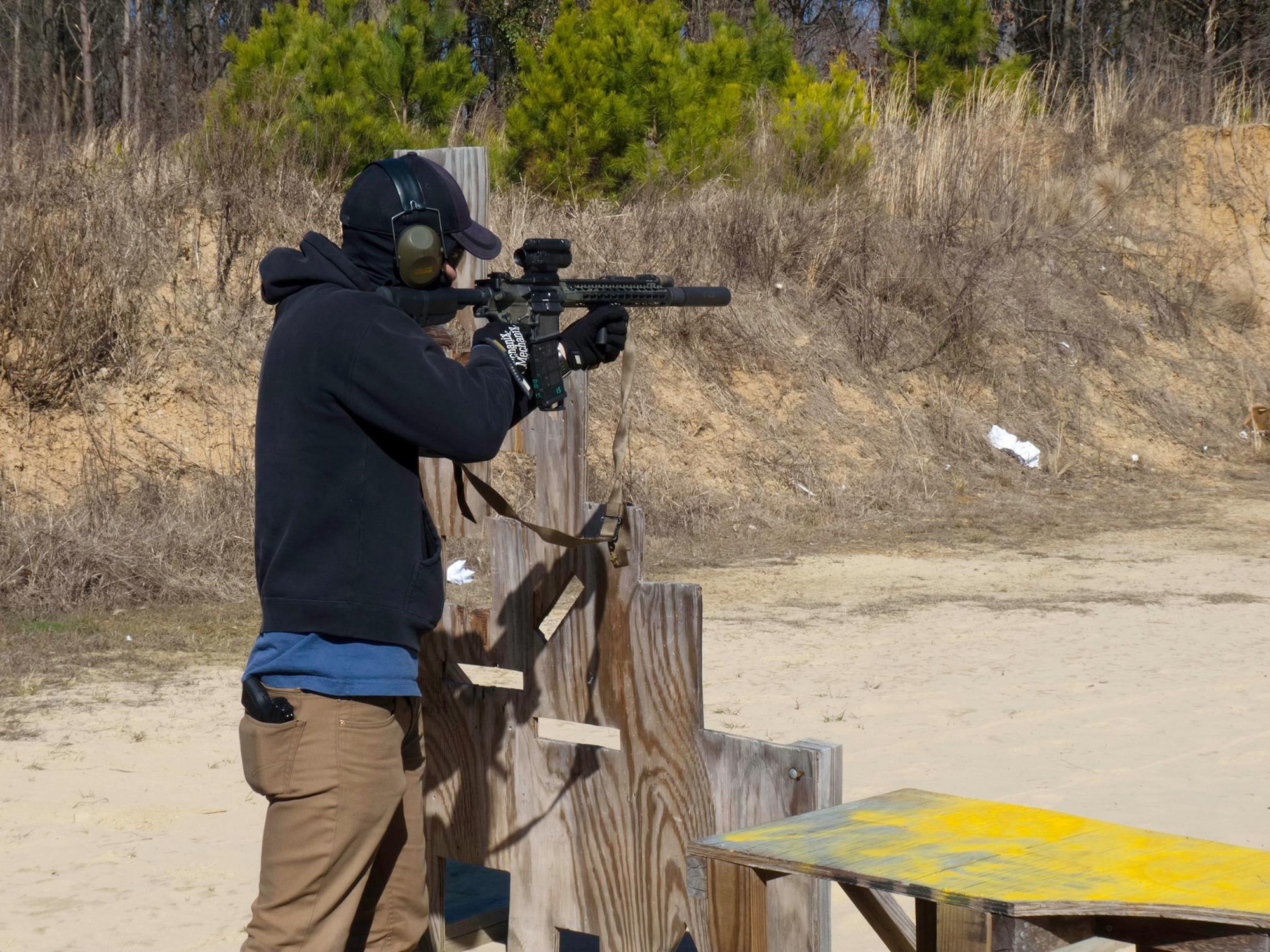 A member of the SJ Shooting Club uses a scope to locate his target during a club outing. The group includes service members, retirees, spouses and civilians – all of whom are committed to gun safety. (U.S. Air Force Courtesy Photo)