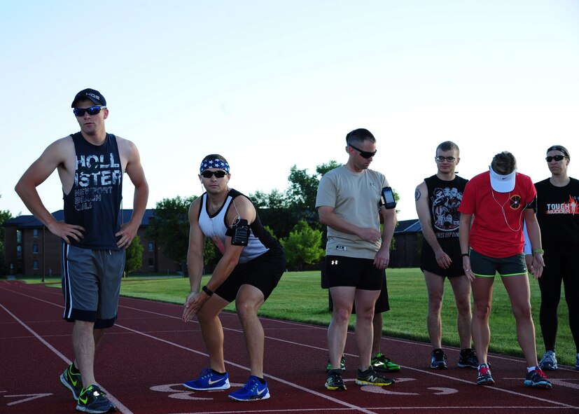 Airmen prepare to start running for the Grand Forks Air Force Base 12-hour Relay July 24, 2015. Airmen competed as either a team or individually and collected pledges to raise money for the Wounded Airman Program. Teams were required to have at least one person running at all times during the event. (U.S. Air Force photo by Airman 1st Class Ryan Sparks/released)