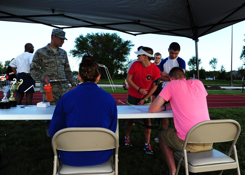 Airmen register for the Grand Forks Air Force Base 12-hour Relay July 24, 2015. Airmen competed as teams or individuals and collected pledges for the mileage they completed. The relay raised funds for the Wounded Airman Program. (U.S. Air Force photo by Airman 1st Class Ryan Sparks/released)