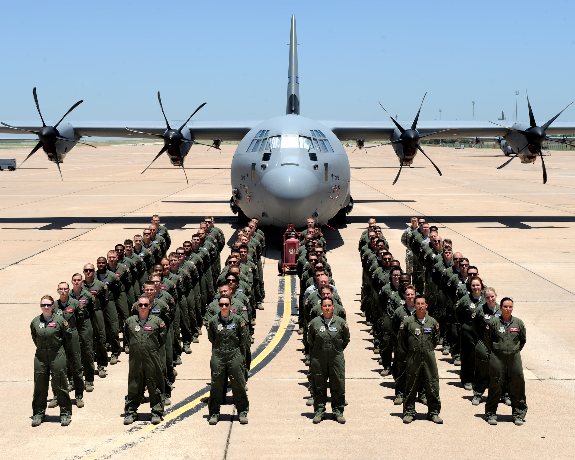 Dyess loadmasters from the 39th and 40th airlift squadrons stand in front of a C-130J Super Hercules, July 13, 2015, Dyess Air Force Base, Texas. Currently, there are 147 loadmasters stationed at Dyess who deploy all over the world dropping cargo and personnel. (U.S. Air Force photo by Airman Quay Drawdy/ Released)