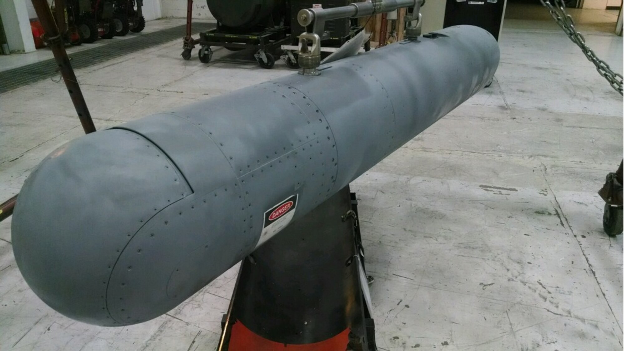 A targeting pod is hoisted in preparation for transport at Hill's LANTIRN CRF. 