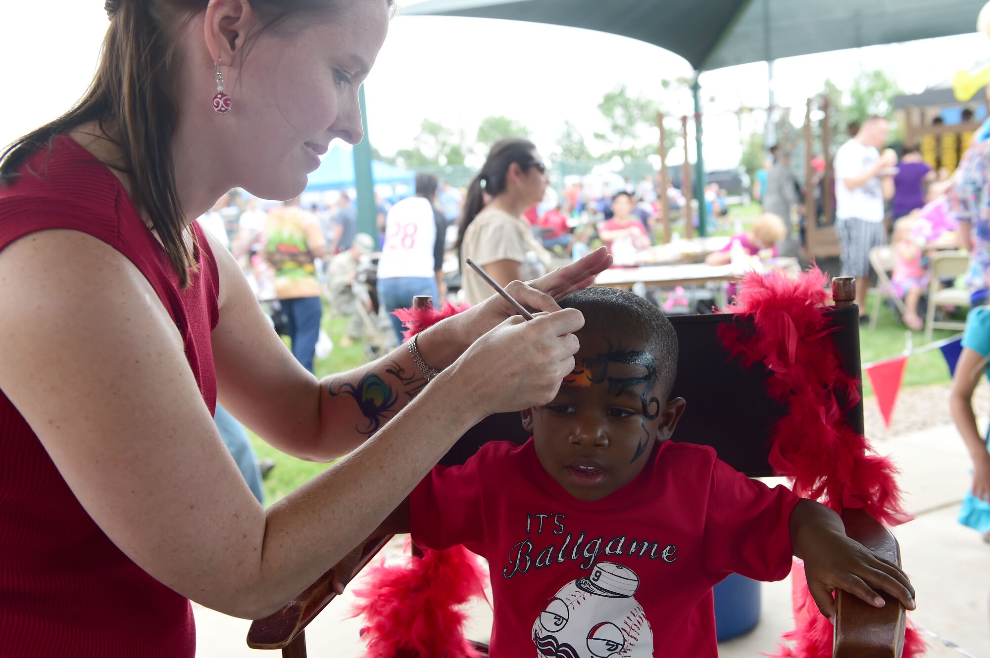 A child gets his face painted during FunFest July 24, 2015, at Buckley Air Force Base, Colo. FunFest is an annual base-wide event that includes family-friendly games and activities, community involvement and local business sponsors. (U.S. Air Force photo by Airman 1st Class Luke W. Nowakowski/Released)