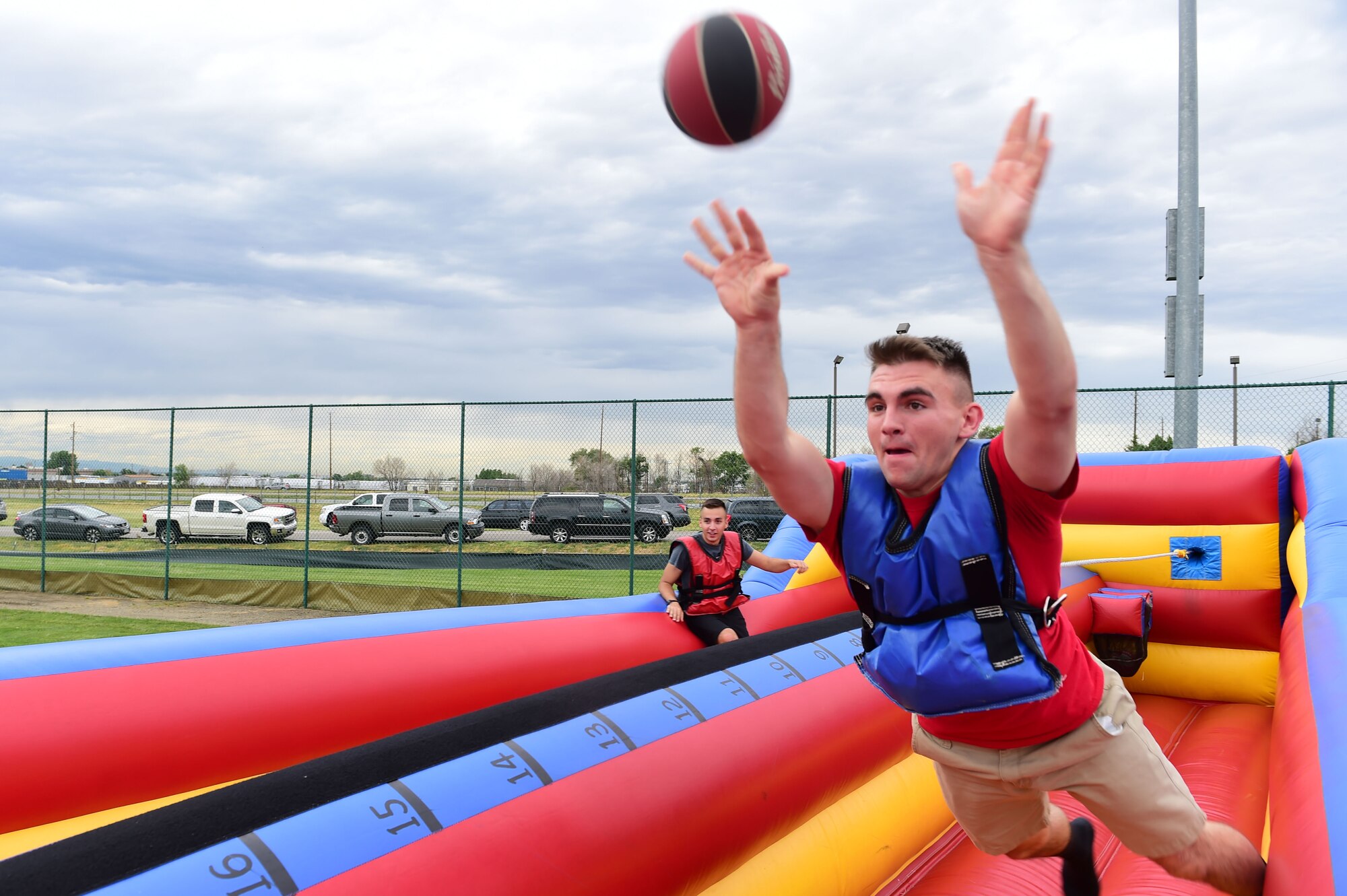 Airman 1st Class Dakota Osborne, 2nd Space Warning Squadron space systems operator, tries to make a basket during FunFest July 24, 2015, at Buckley Air Force Base, Colo. FunFest is an annual base-wide event that includes family-friendly games and activities, community involvement and local business sponsors. (U.S. Air Force photo by Airman 1st Class Luke W. Nowakowski/Released) 