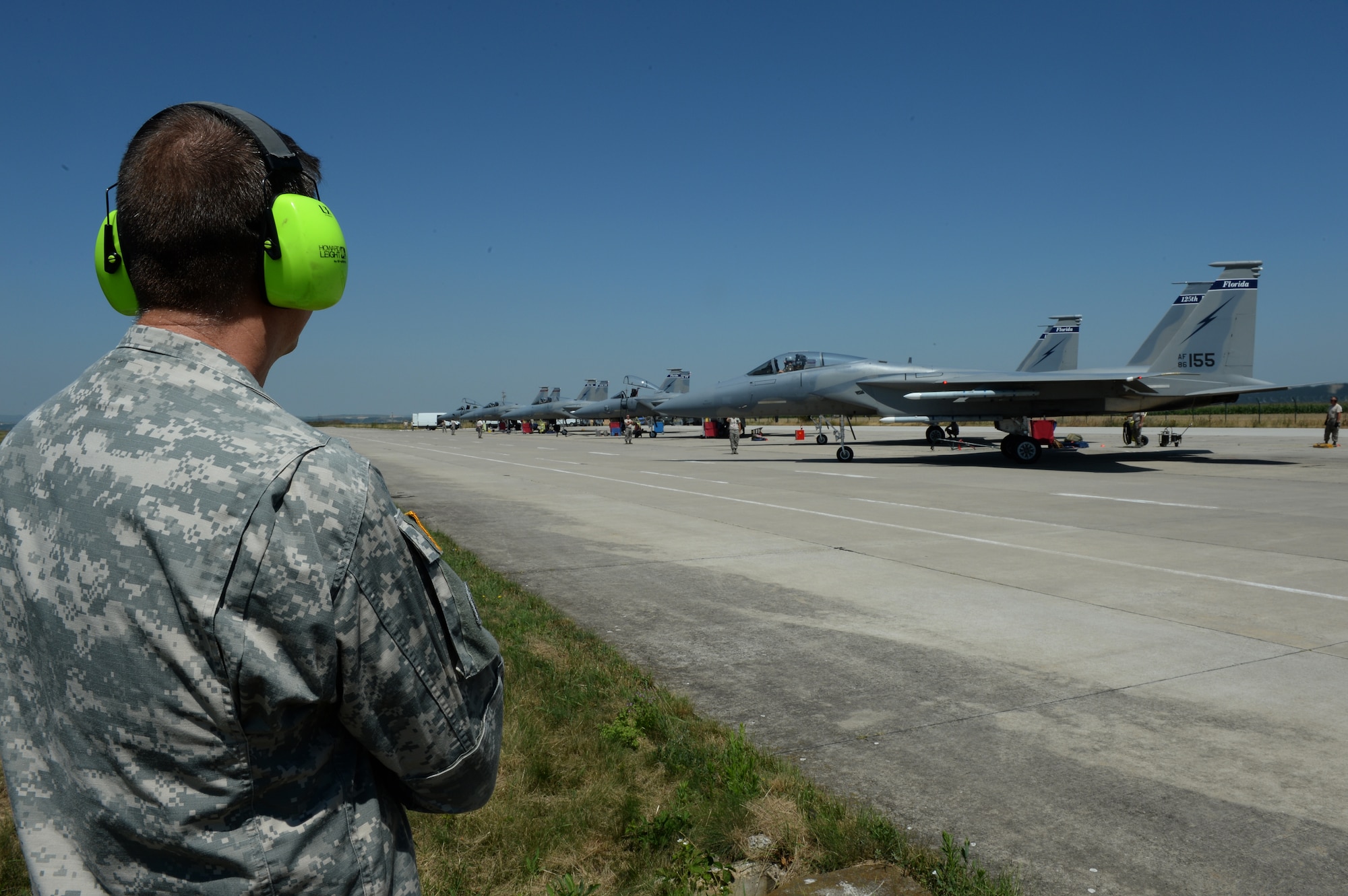 U.S. National Guard Maj. Gen. Daniel Hokanson, Oregon National Guard Adjutant General, watches an F-15C Eagle fighter aircraft taxi during a base tour at Campia Turzii, Romania, July 22, 2015. Hokanson visited the 123rd Expeditionary Fighter Squadron during their theater security package deployment to Campia Turzii. The aircraft deployed to Romania in support of Operation Atlantic Resolve to bolster air power capabilities while underscoring the U.S. commitment to European security and stability. (U.S. Air Force Senior Airman Dylan Nuckolls/Released) 