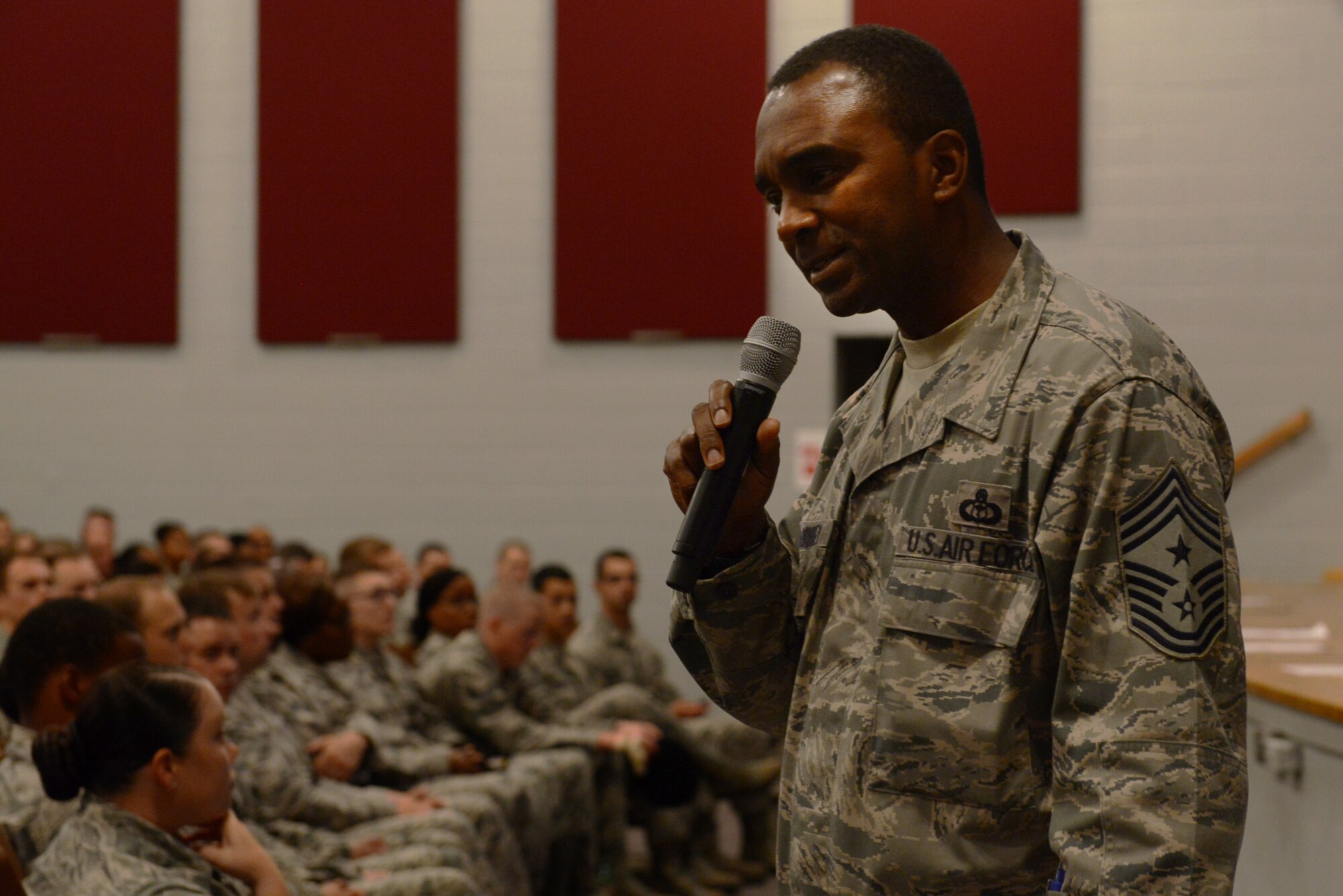 U.S Air Force Chief Master Sgt. Christopher McKinney, 20th Fighter Wing command chief, speaks to Airmen during an enlisted call at Shaw Air Force Base, S.C., July 23, 2015. McKinney, a Luling, Texas, native who joined the Air Force in 1987, spoke to the Airmen about trust, loyalty, and standards. He introduced the beginning of the “Shaw Standard” initiative to go along with Airman Up! (U.S. Air Force photo by Senior Airman Diana M. Cossaboom/Released)