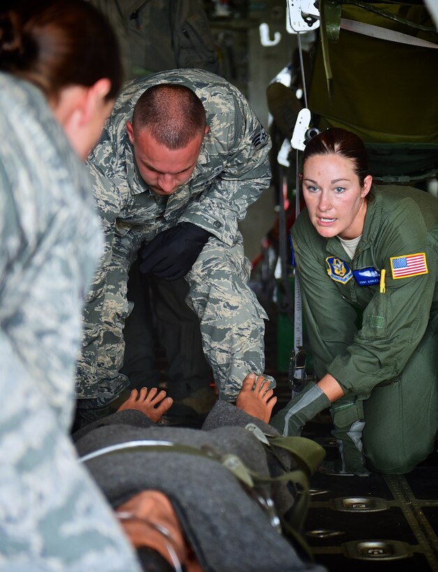 Tech. Sgt. Ashely Langley, a 932nd Airlift Wing Aeromedical Evacuation Squadron medical technician, gives patient litter lifting instructions during a simulated patient off-load of a C-130 aircraft, July 11, 2015, Scott Air Force Base Ill.   Medical techs with the 932nd AW Aeromedical Staging Squadron assisted with the patient moment during an inspection for the 932nd AES.    (U.S. Air Force photo / Tech. Sgt. Christopher Parr)