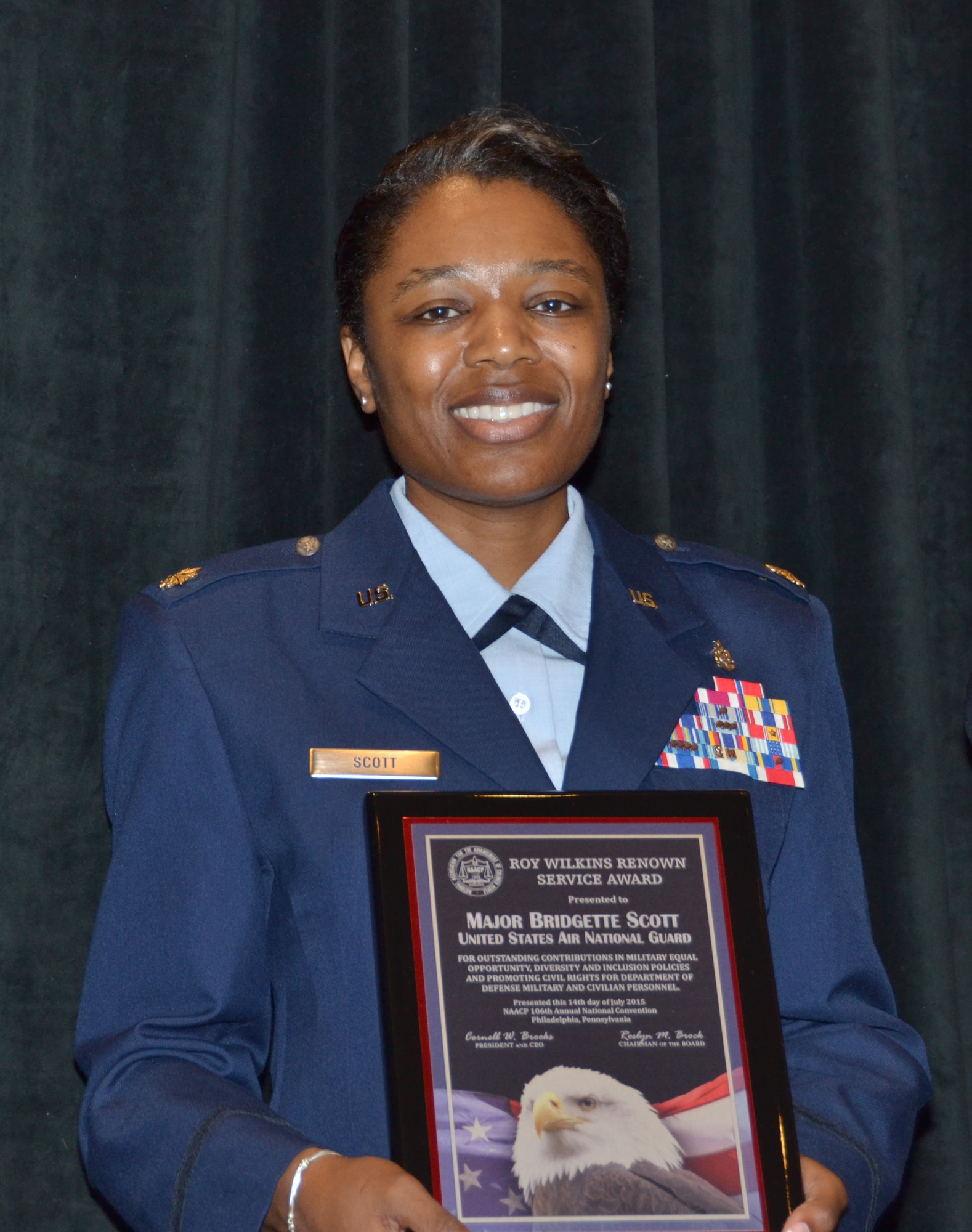 Maj. Bridgette Scott, 188th Medical Group administrative officer, presents her 2015 National Association for the Advancement of Colored People Roy Wilkins Renown Service Award at the Loews Philadelphia Hotel, Philadelphia, July 14, during the 2015 Annual NAACP Armed Services and Veterans Affairs Awards Luncheon. The NAACP recognizes Department of Defense personnel from the military services and defense agencies for outstanding accomplishments in human relations, equal opportunity, civil rights and is named after civil rights advocate and former NAACP executive director Roy Wilkins. (Courtesy photo)