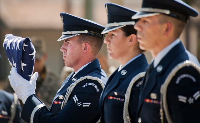 Airman 1st Class Brandon Pesci holds the flag during an Honor Guard graduation ceremony June 15 at Eglin Air Force Base, Fla. Approximately 12 new Airmen graduated from the 80-plus-hour course. The graduation performance includes flag detail, rifle volley, pall bearers and bugler for friends, family and unit commanders. (U.S. Air Force photo/Samuel King Jr.)
