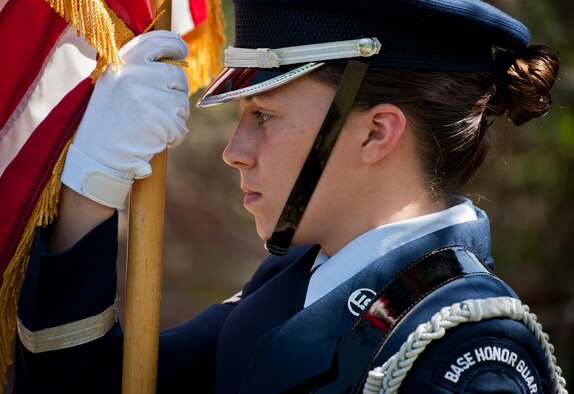Airman 1st Class Jenna Carr carries the American Flag during an Honor Guard graduation ceremony June 15 at Eglin Air Force Base, Fla. Approximately 12 new Airmen graduated from the 80-plus-hour course. The graduation performance includes flag detail, rifle volley, pall bearers and bugler for friends, family and unit commanders. (U.S. Air Force photo/Samuel King Jr.)