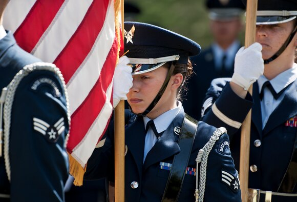 Airman 1st Class Jenna Carr carries the American Flag during an Honor Guard graduation ceremony June 15 at Eglin Air Force Base, Fla. Approximately 12 new Airmen graduated from the 80-plus-hour course. The graduation performance includes flag detail, rifle volley, pall bearers and bugler for friends, family and unit commanders. (U.S. Air Force photo/Samuel King Jr.)