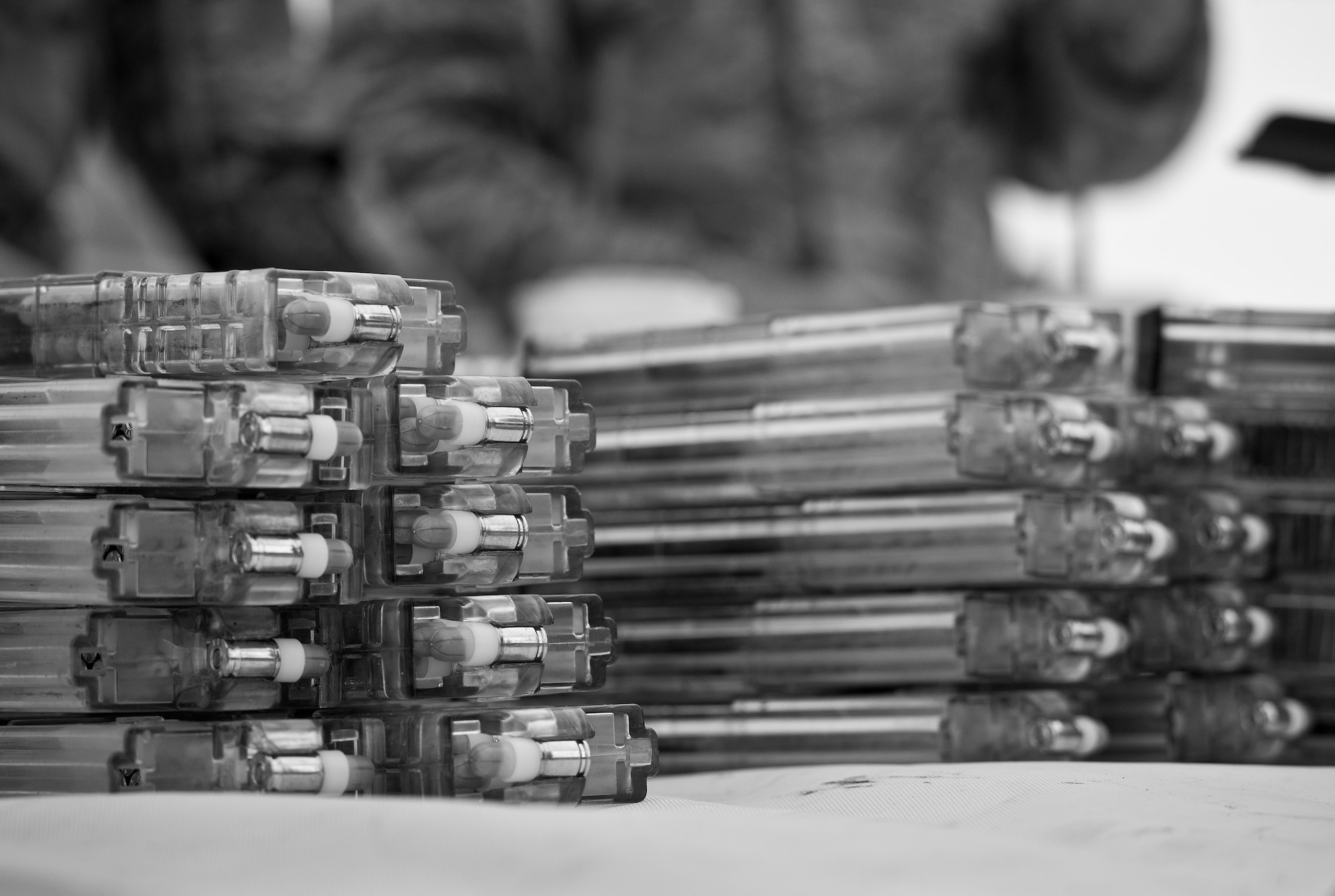 Magazines of simmunition rounds sit ready for use prior to a shoot, move and communicate drill in June at Eglin Air Force Base, Fla.  The mandatory training requirement is in addition to annual weapons qualification training.  The exercise consists of Airmen firing simmunition ammo while advancing toward, away from and to the side of a target.  This is followed by a building sweep and clear drill.  The Defenders perform the highly kinetic training at Eglin’s Base Tango range.  The range was previously used for security forces pre-deployment training.  (U.S. Air Force photo/Samuel King Jr.)