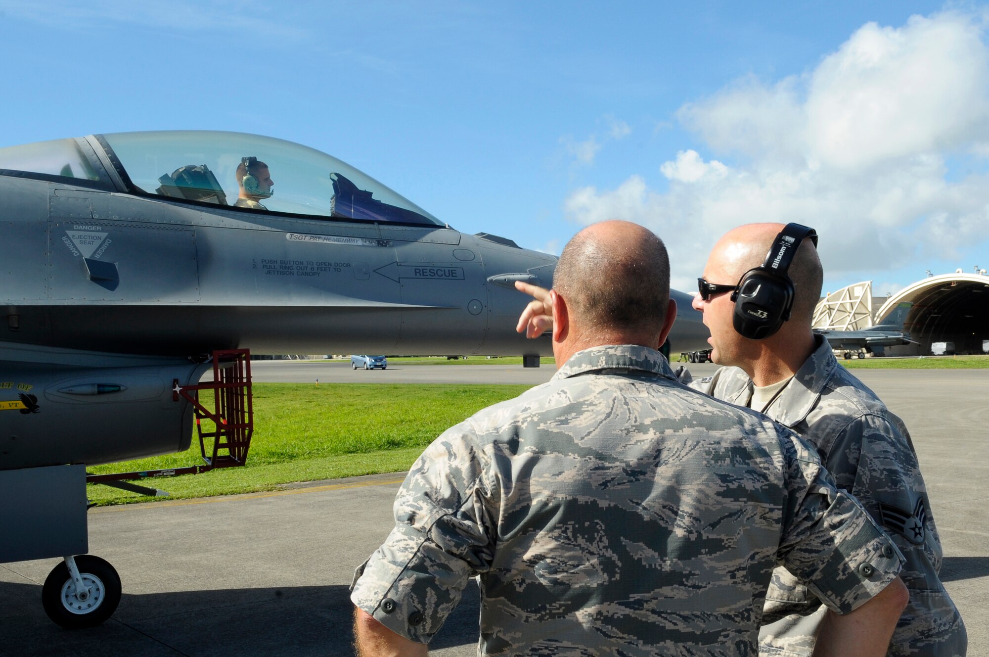 U.S. Air Force Brig. Gen Joel A. Clark, 158th Fighter Wing assistant adjutant general, speaks with Senior Airman Joe Palumbo, 158th FW fuels systems technician, during an operations check after a flight on Kadena Air Base, Japan, July 23, 2015. Air Combat Command routinely deploys fighter aircraft to the region to provide U.S. Pacific Command and Pacific Air Forces with Theater Security Packages, which help maintain a deterrent against threats to regional security and stability and demonstrate the continuing U.S. commitment to the region, the Japan-U.S. alliance and the defense of Japan. (U.S. Air Force photo by Airman 1st Class Zackary A. Henry)