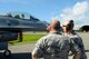 U.S. Air Force Brig. Gen Joel A. Clark, 158th Fighter Wing assistant adjutant general, speaks with Senior Airman Joe Palumbo, 158th FW fuels systems technician, during an operations check after a flight on Kadena Air Base, Japan, July 23, 2015. Air Combat Command routinely deploys fighter aircraft to the region to provide U.S. Pacific Command and Pacific Air Forces with Theater Security Packages, which help maintain a deterrent against threats to regional security and stability and demonstrate the continuing U.S. commitment to the region, the Japan-U.S. alliance and the defense of Japan. (U.S. Air Force photo by Airman 1st Class Zackary A. Henry)